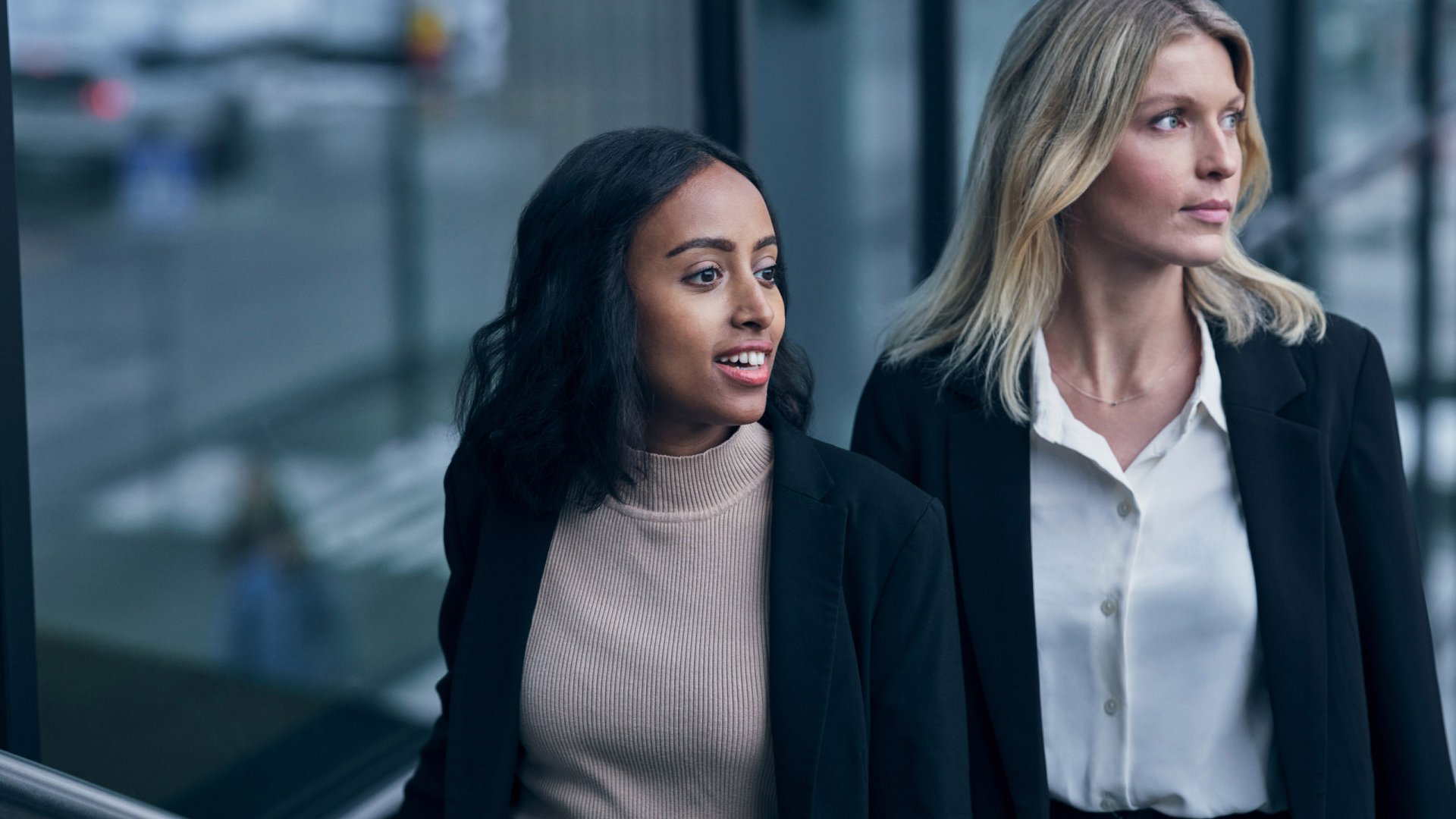 Two business women looking away