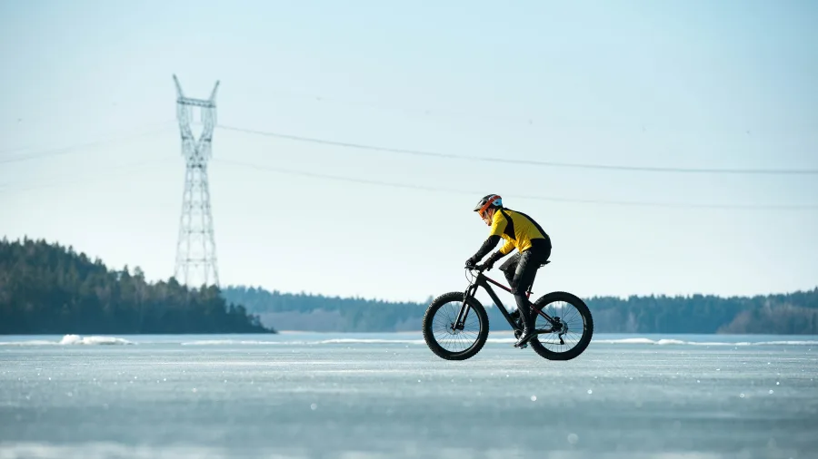 Man cycling on a frozen lake