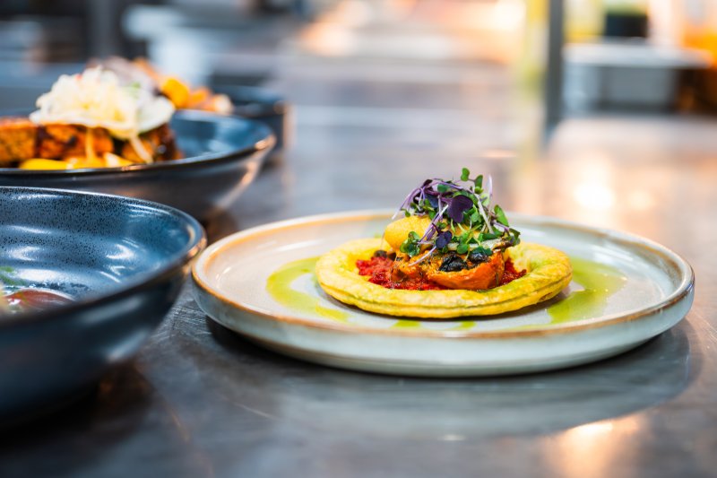 Contemporary plated dish prepared by students at Academy Restaurant using fresh seasonal ingredients.
