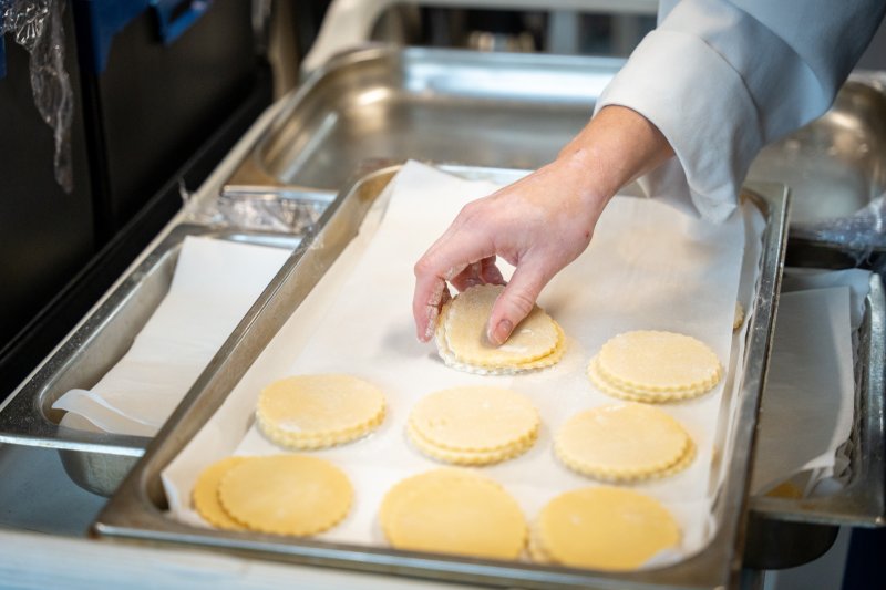 Ulster University pastry student preparing pastry rounds in the Academy Restaurant professional kitchen.