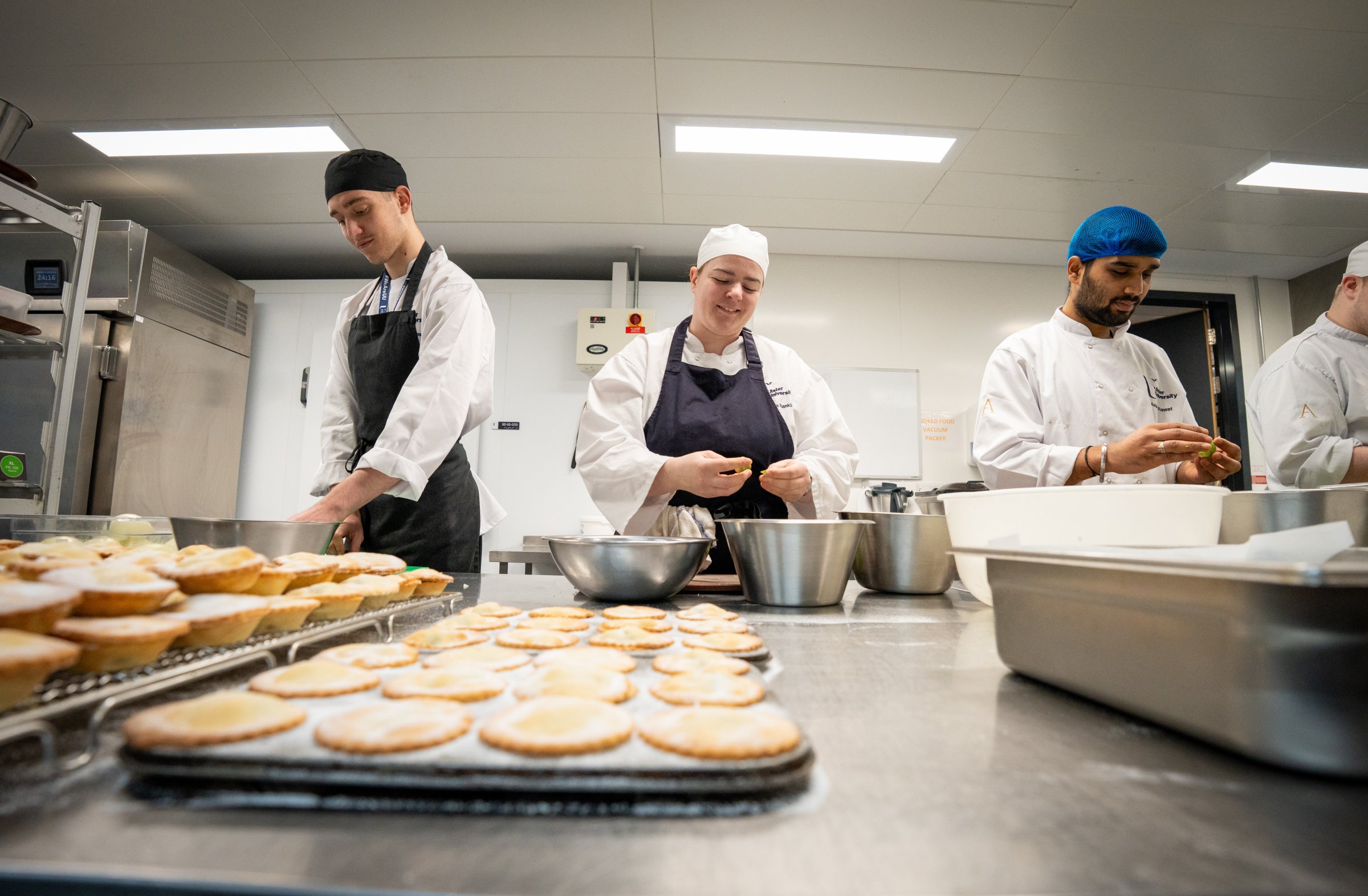 Ulster University student prepping food in restaurant kitchen