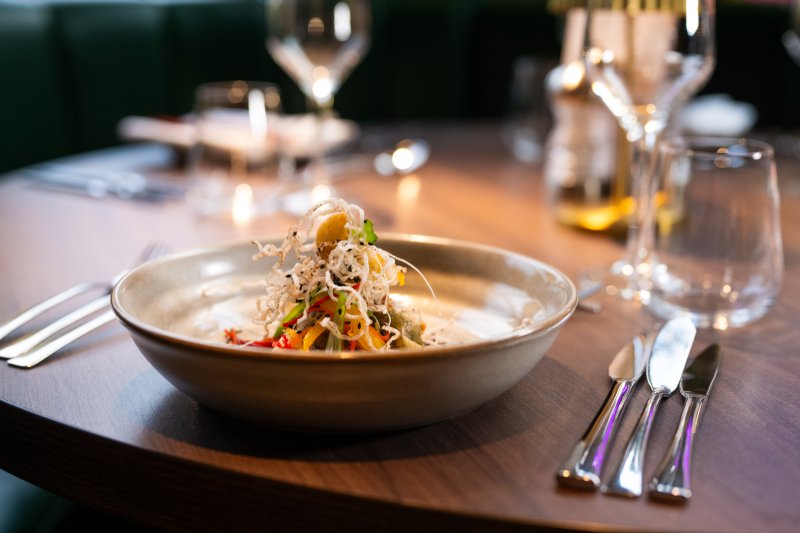 Asian inspired food dish plated up on dining table within Academy Restaurant