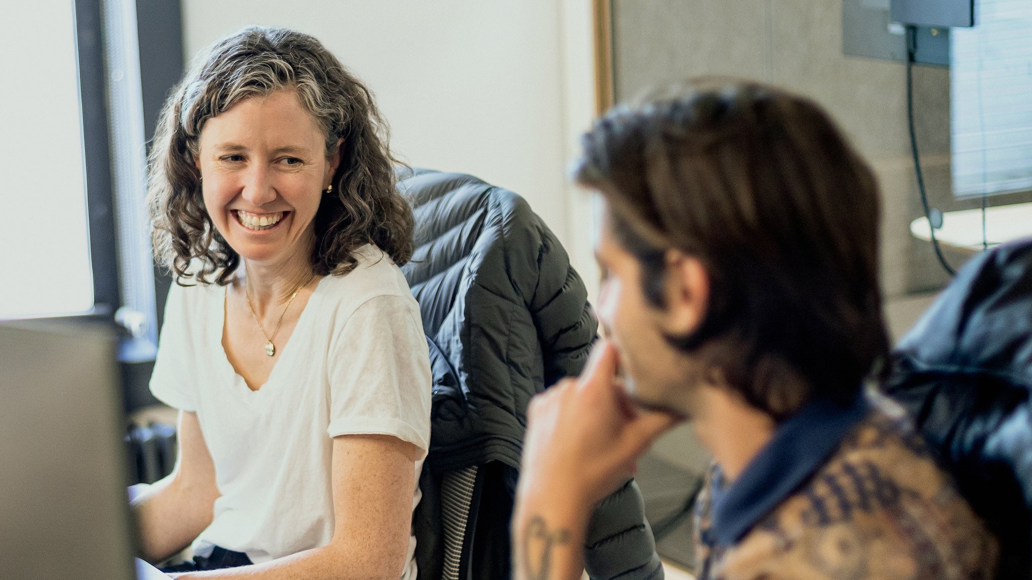 two people chatting at the desk