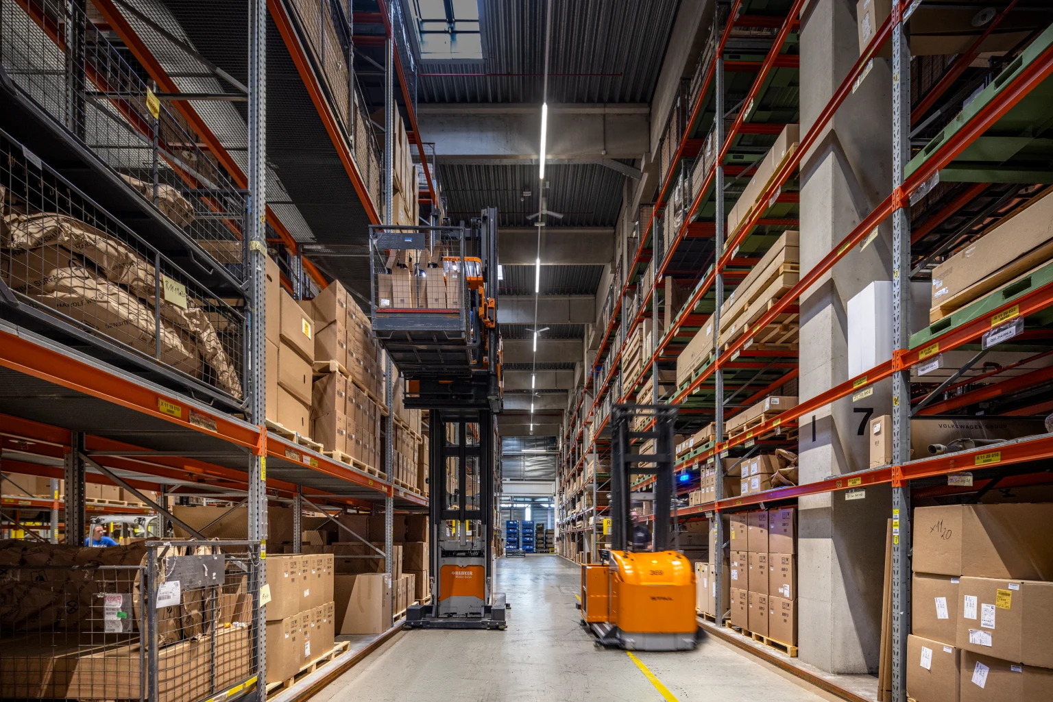In high-bay warehouses, wide-beam optics provide the required vertical illuminance levels.