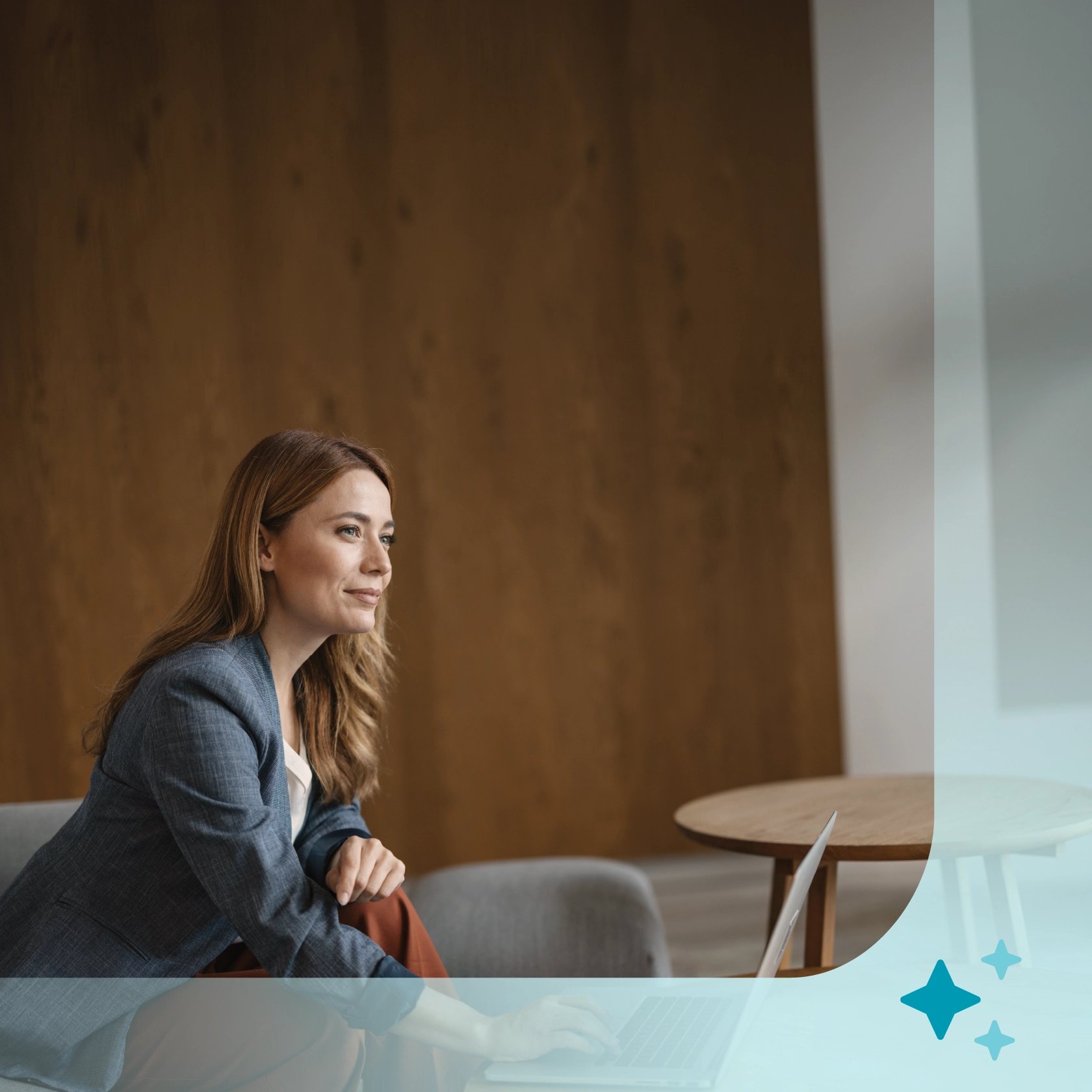 An attorney sitting in an office with a laptop at a table, with an AI star icon