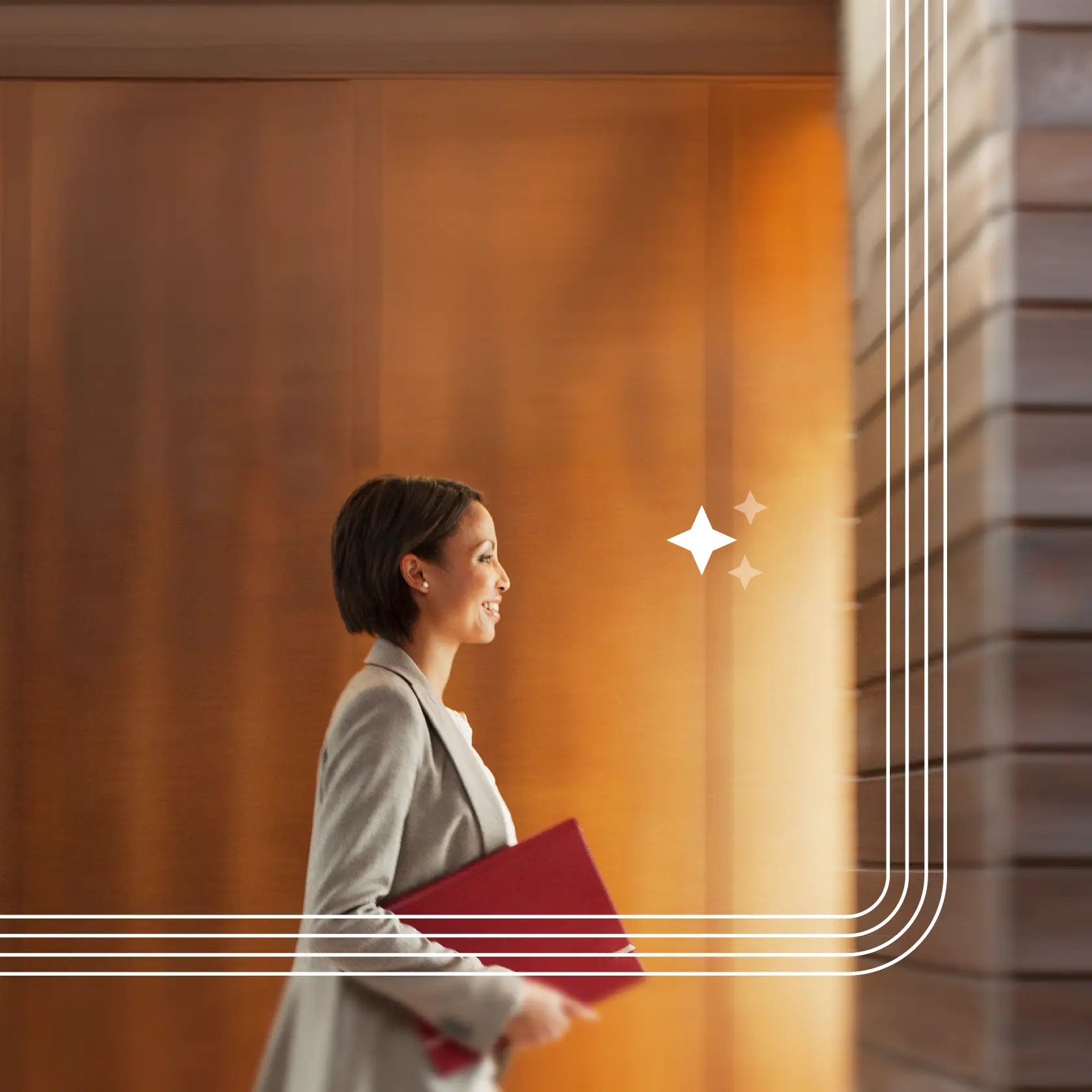 A legal professional walking in an office carrying a folder