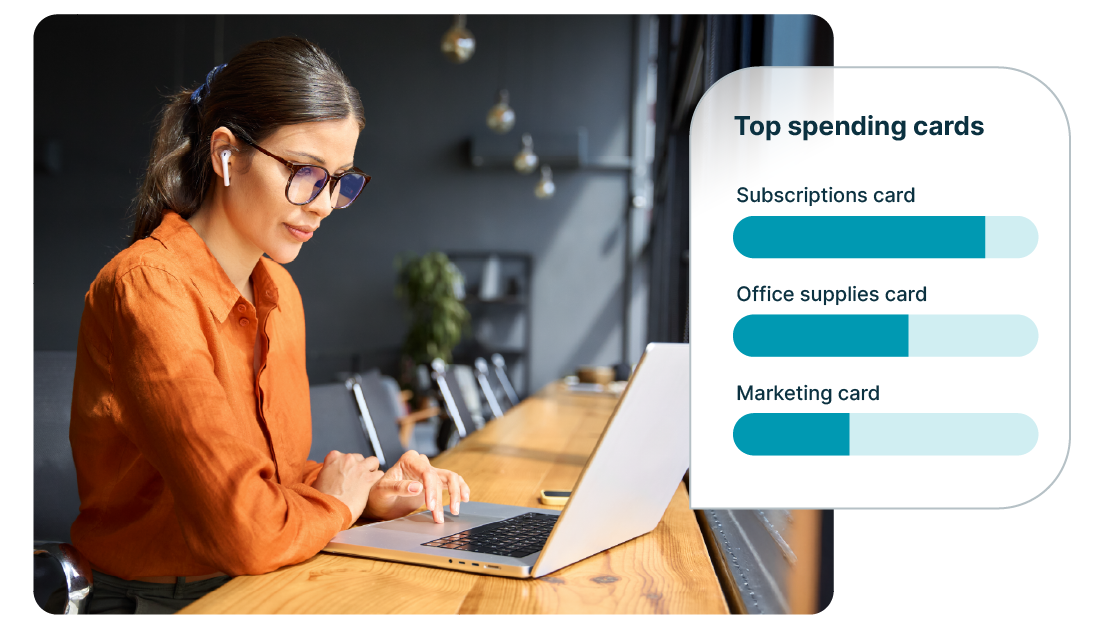 Professional working on a laptop at a desk while a dashboard shows top spending cards, including subscriptions, office supplies, and marketing, illustrating business expense tracking and financial insights.