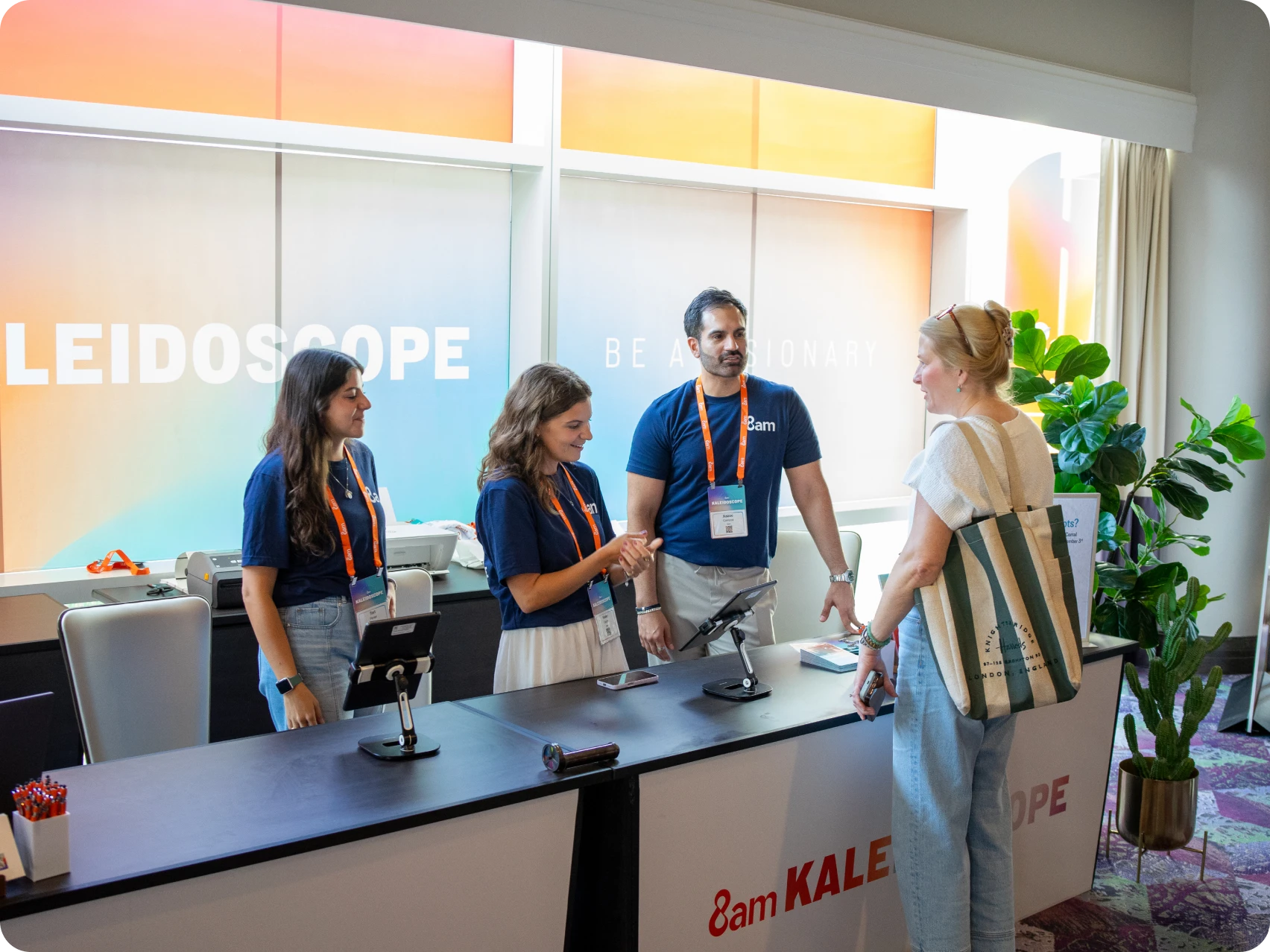 A person stops by the registration desk at Kaleidoscope 2025 and gets information