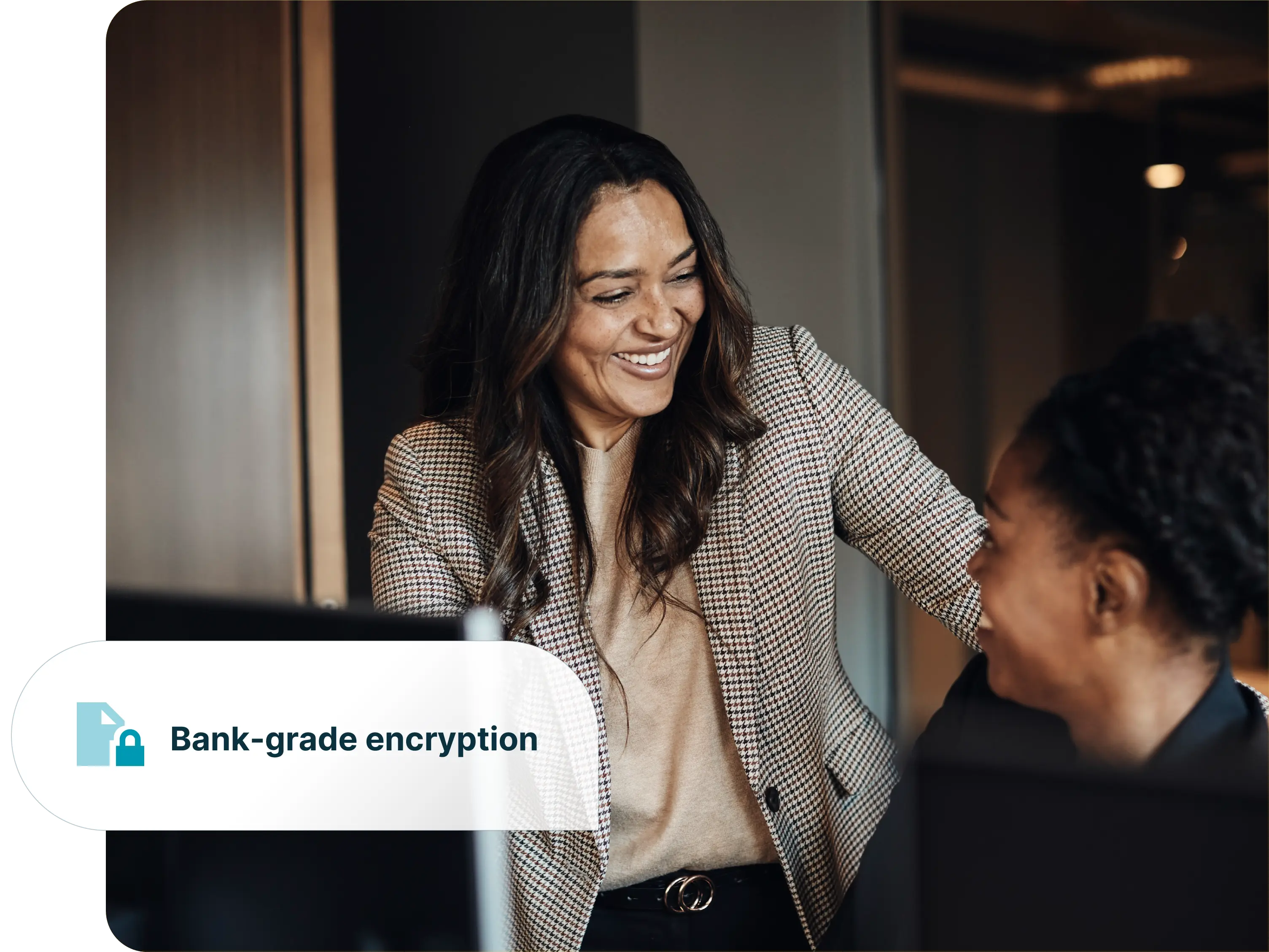 Two professionals collaborating in an office with a bank-grade encryption graphic.