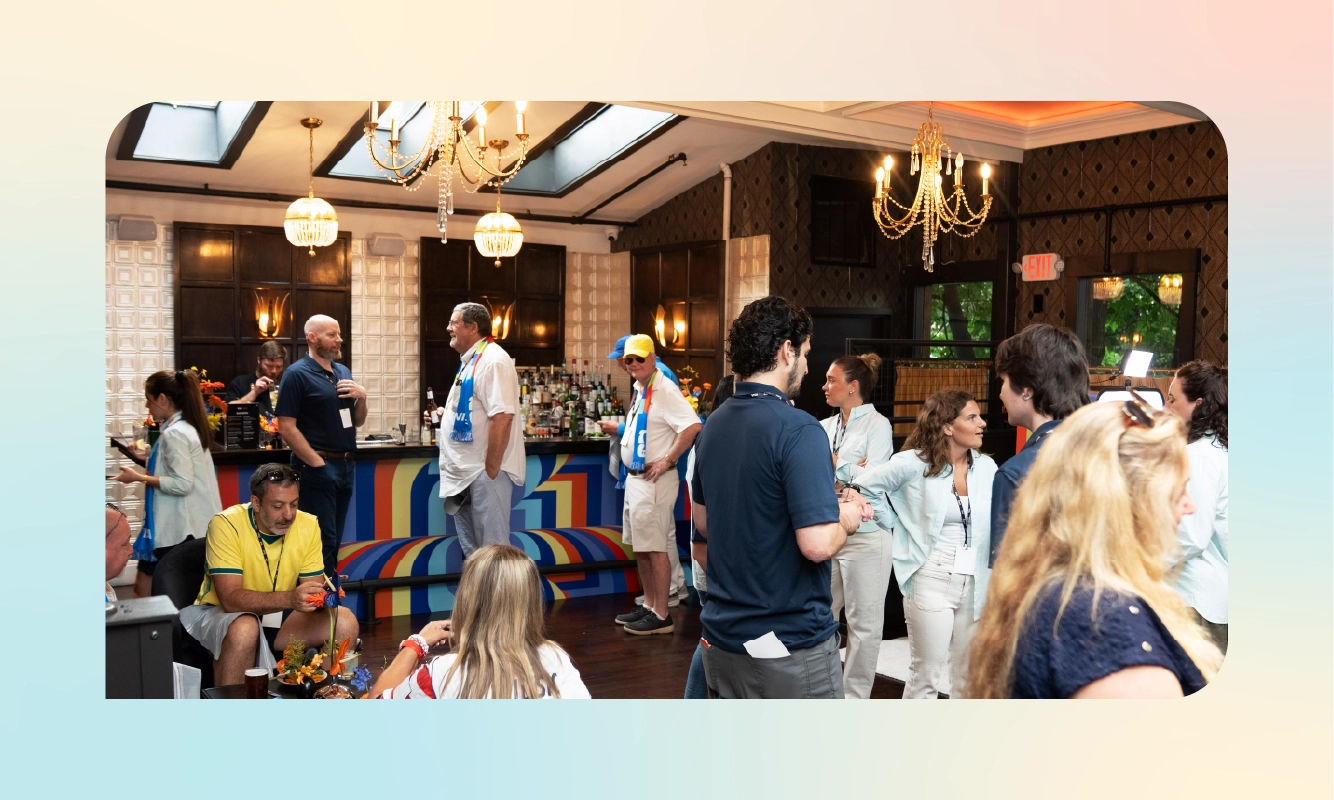 Guests mingle in the lounge-style reception space, with warm lighting and decor set up for the pre-match event.