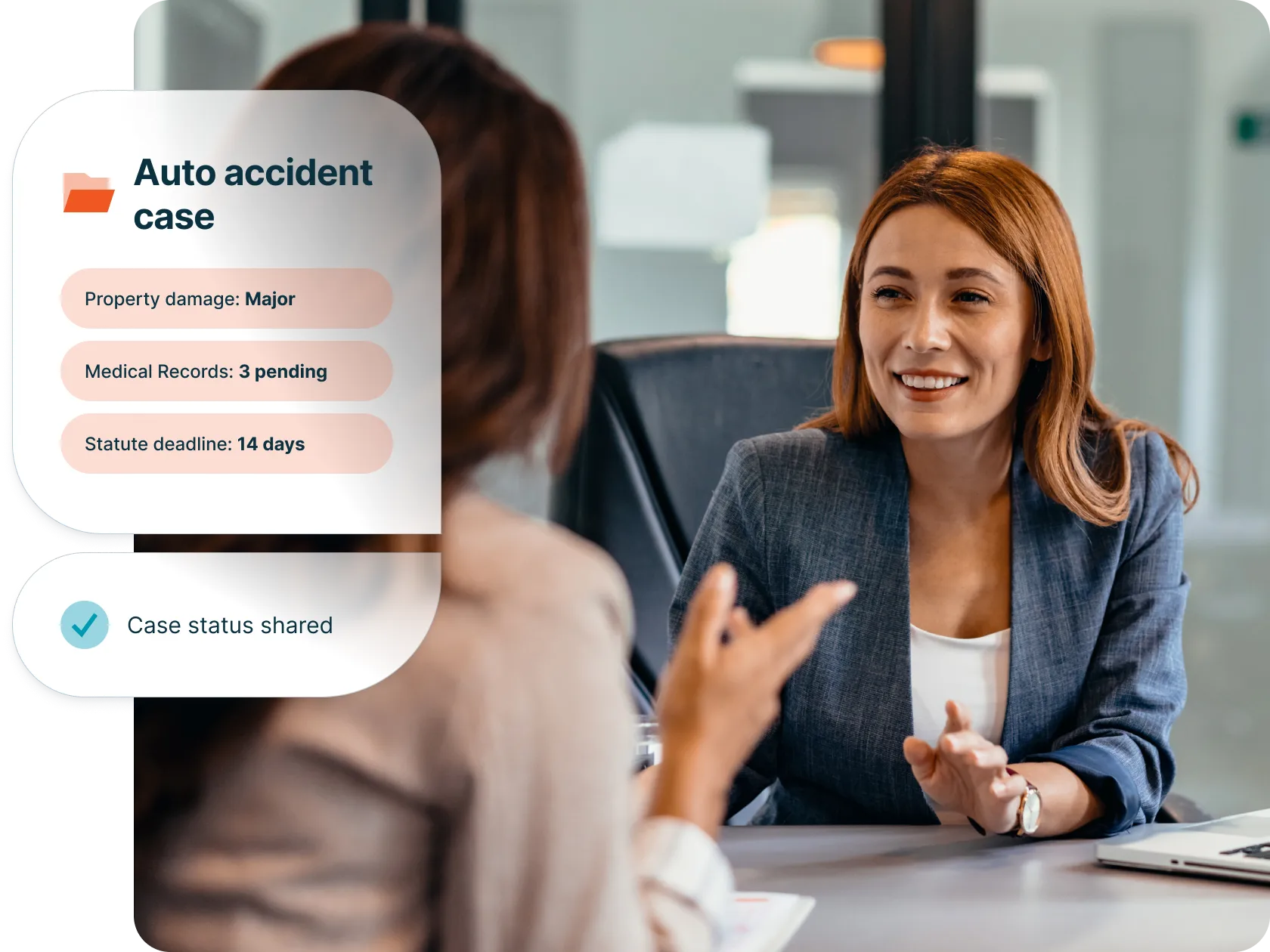 Lawyer talking with a client about an auto accident case with case status features highlight