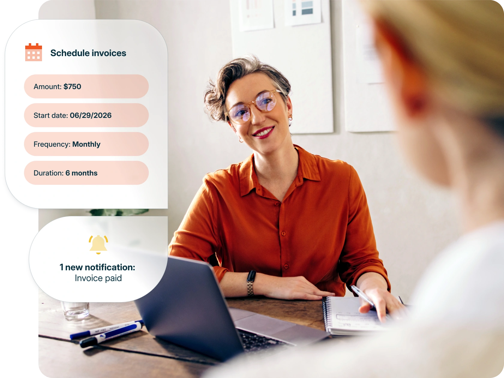 Professional using accounting payment and billing software, reviewing invoice details and subscription pricing with a client on laptop in a modern office setting