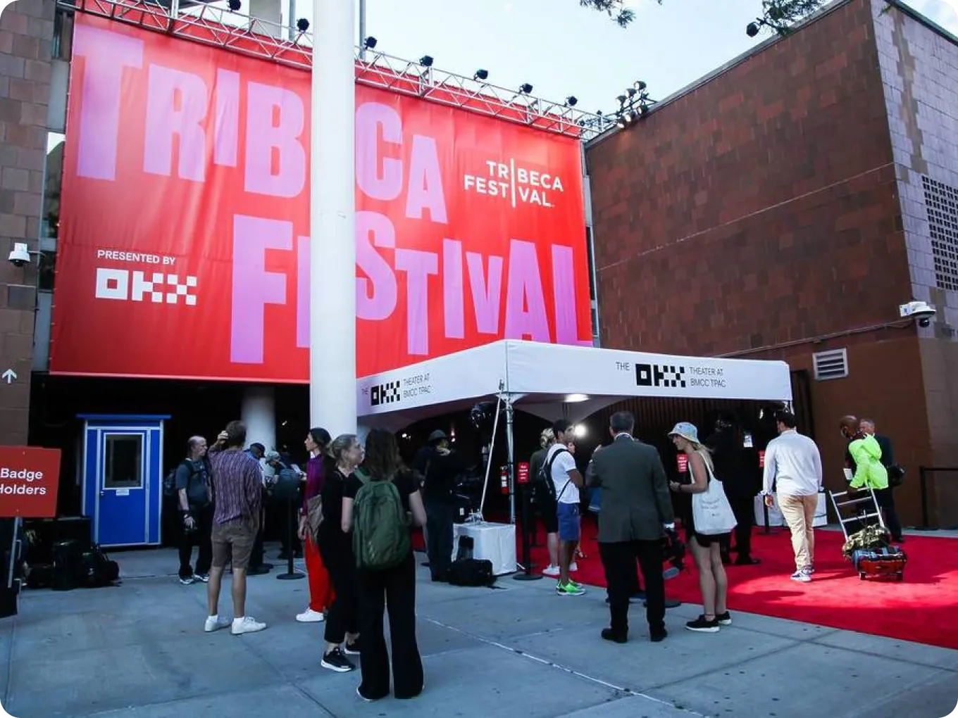 People walking into a theater with the Tribeca film festival logo