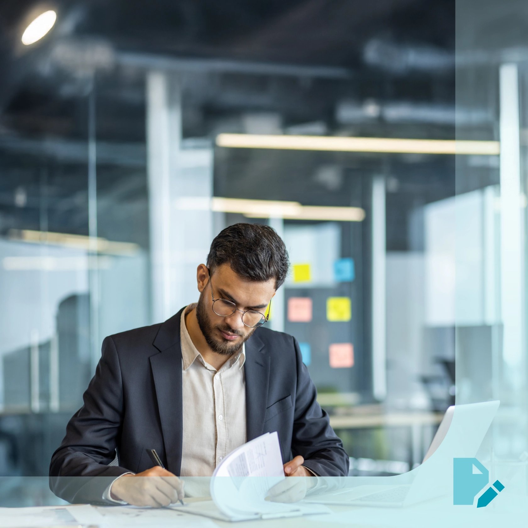 A lawyer focused, drafting legal paperwork at a modern office desk with a laptop