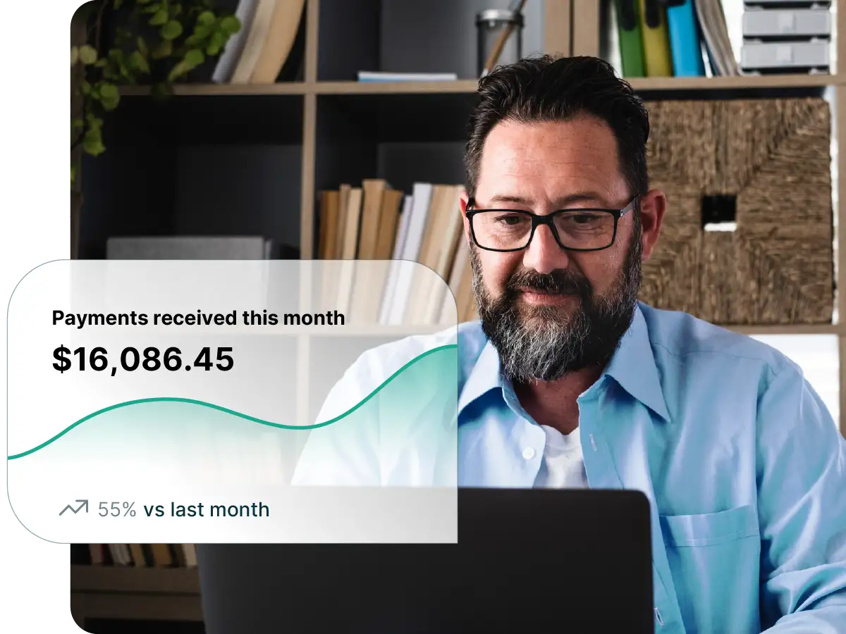 Payment reporting view showing monthly payments received, trend over time, and comparison to last month while a professional reviews financial performance on a laptop.