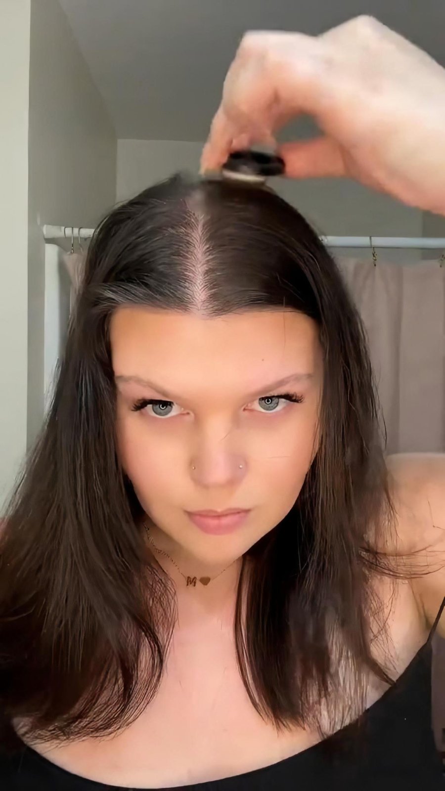 Applying Boldify Hairline Powder in small passes at the roots