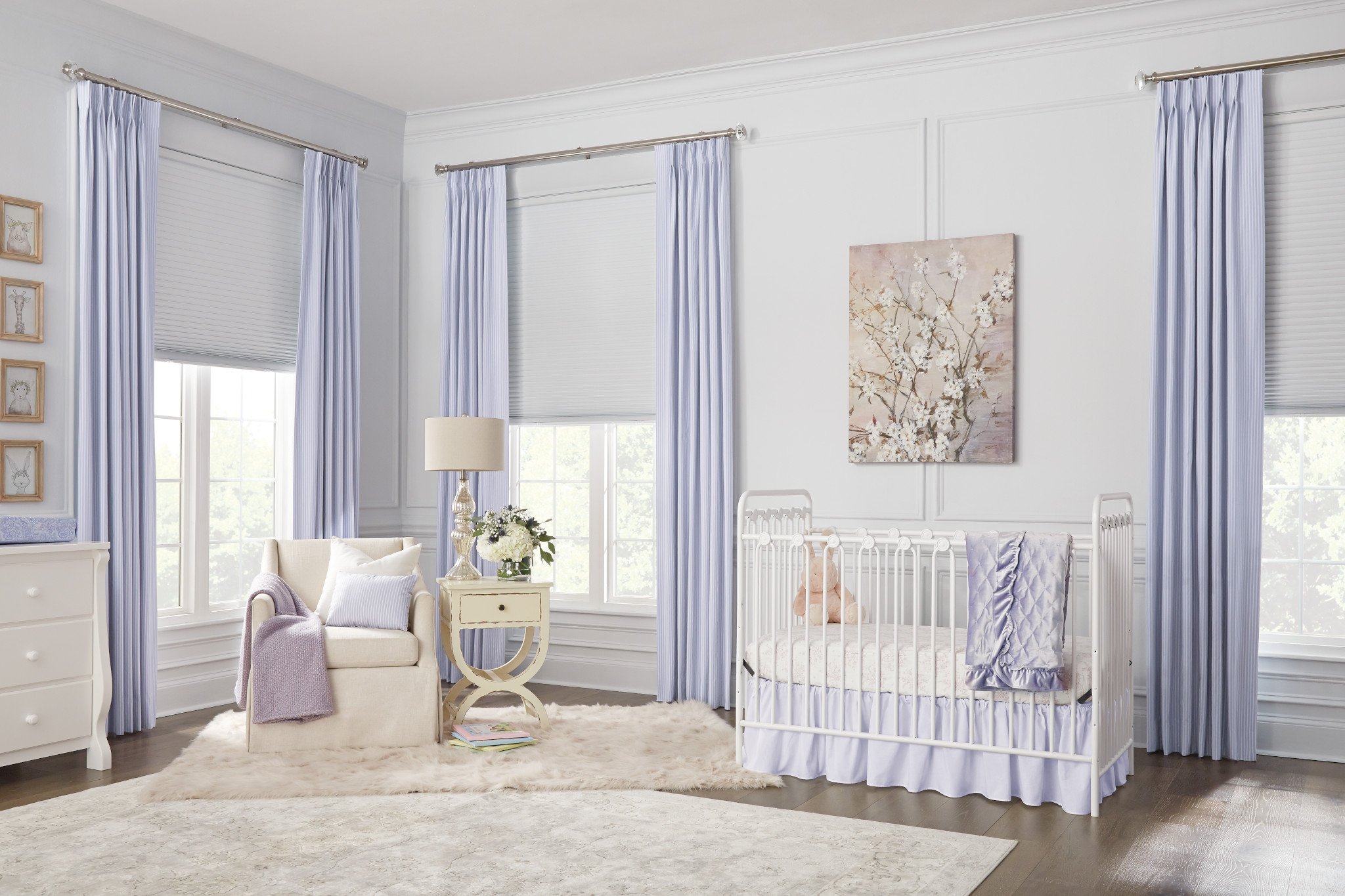 White cellular shades layered with purple drapery in child's room