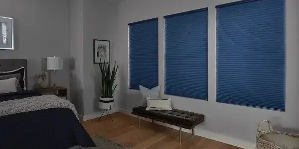 Blue cellular shades in bedroom windows
