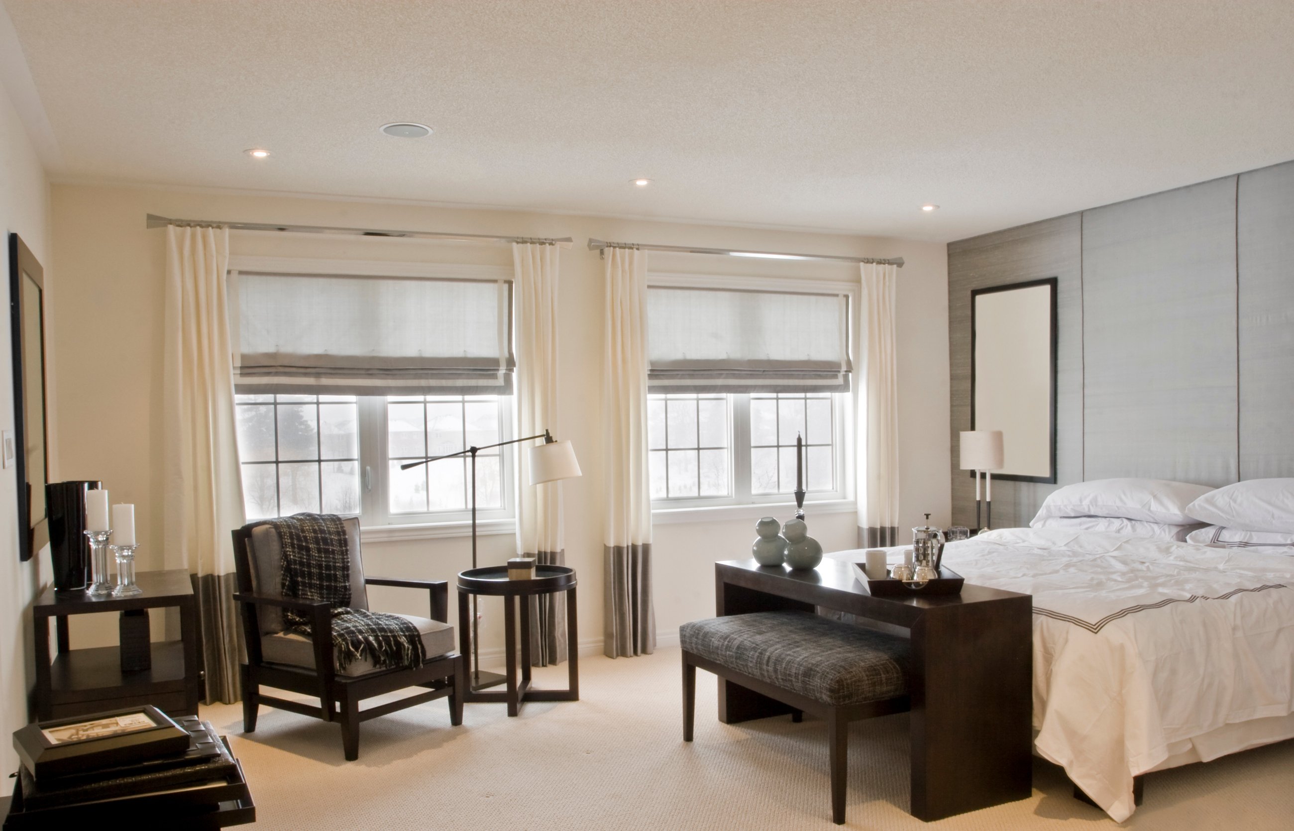 Drapery layered with grey roman shade