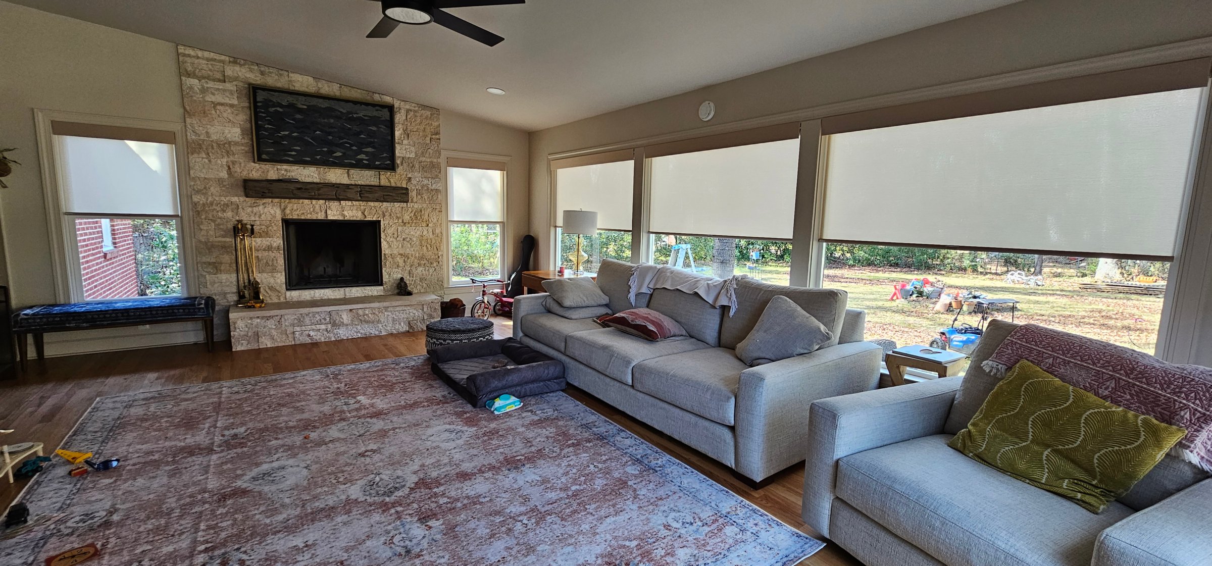 roller-shades-light-grey-wide-livingroom-fireplace