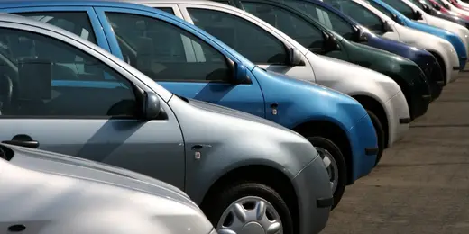 Cars parked in neat rows in a parking lot