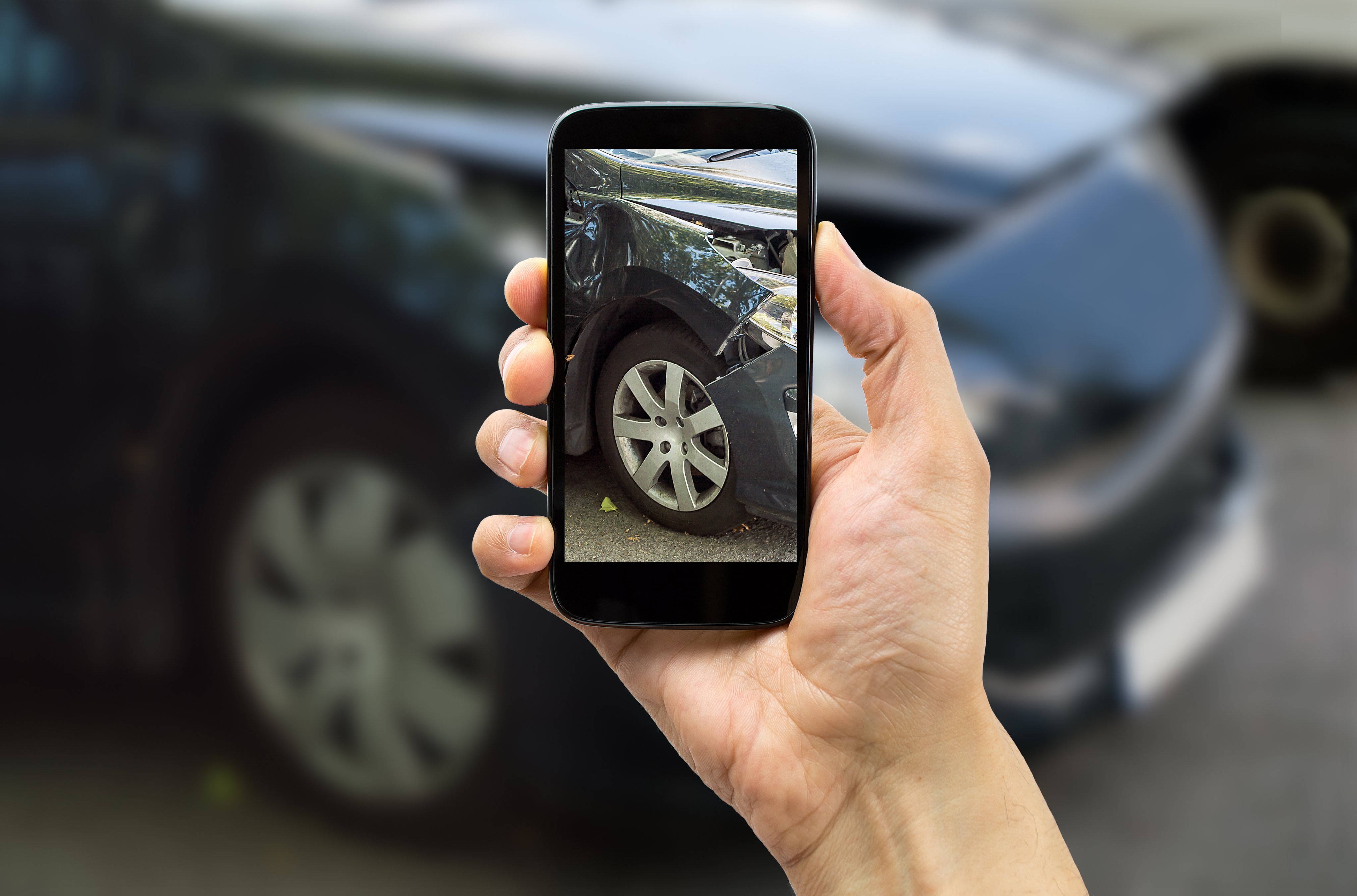 Taking a picture of a wrecked car