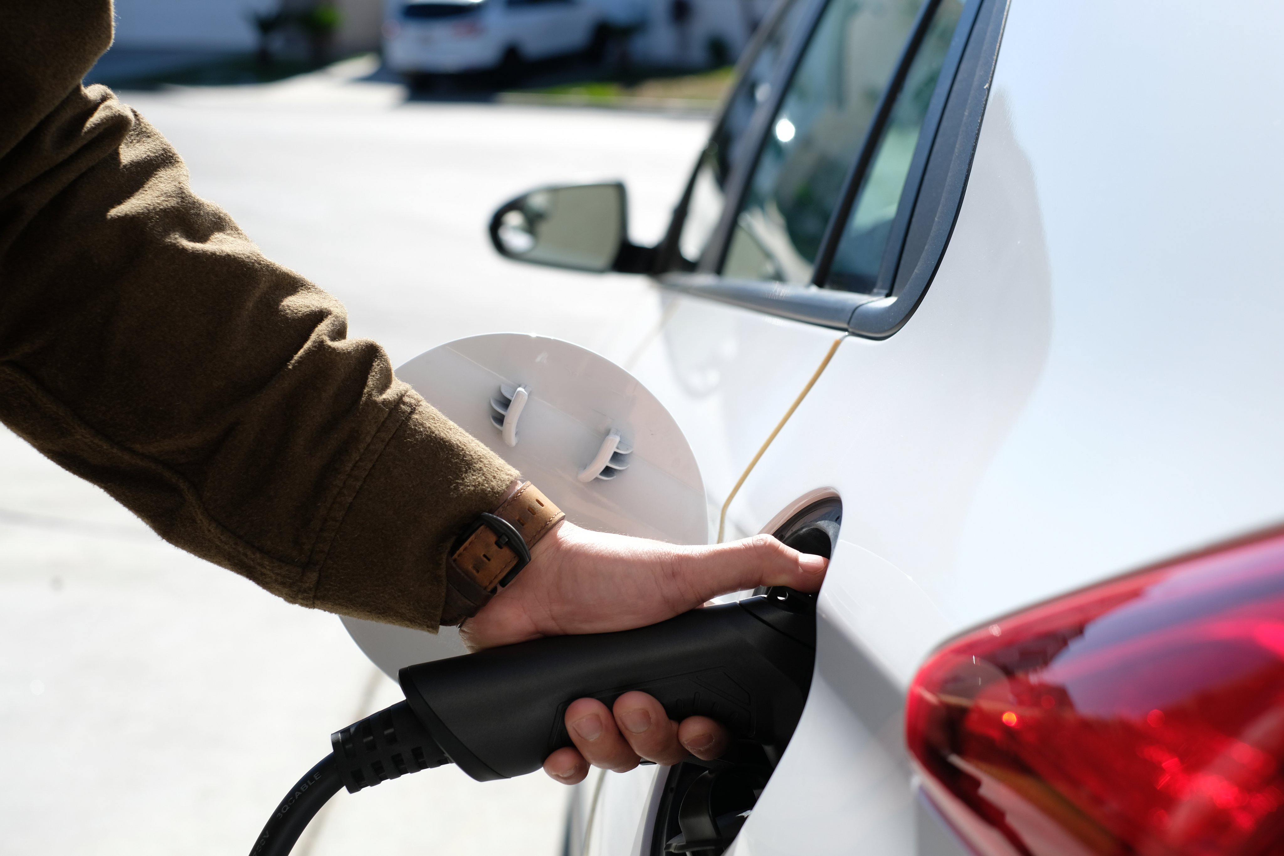 Man is charging EV car electric car, electric vehicle at home