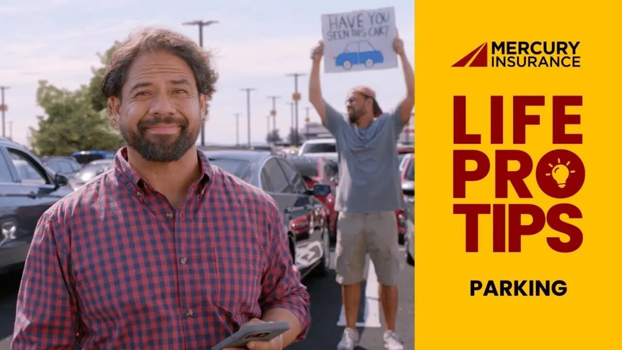 Hispanic man standing in a parking lot with another man behind him holding a sign that reads 'Have you seen this car?'.