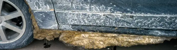A dirty car after using a road salt in winter
