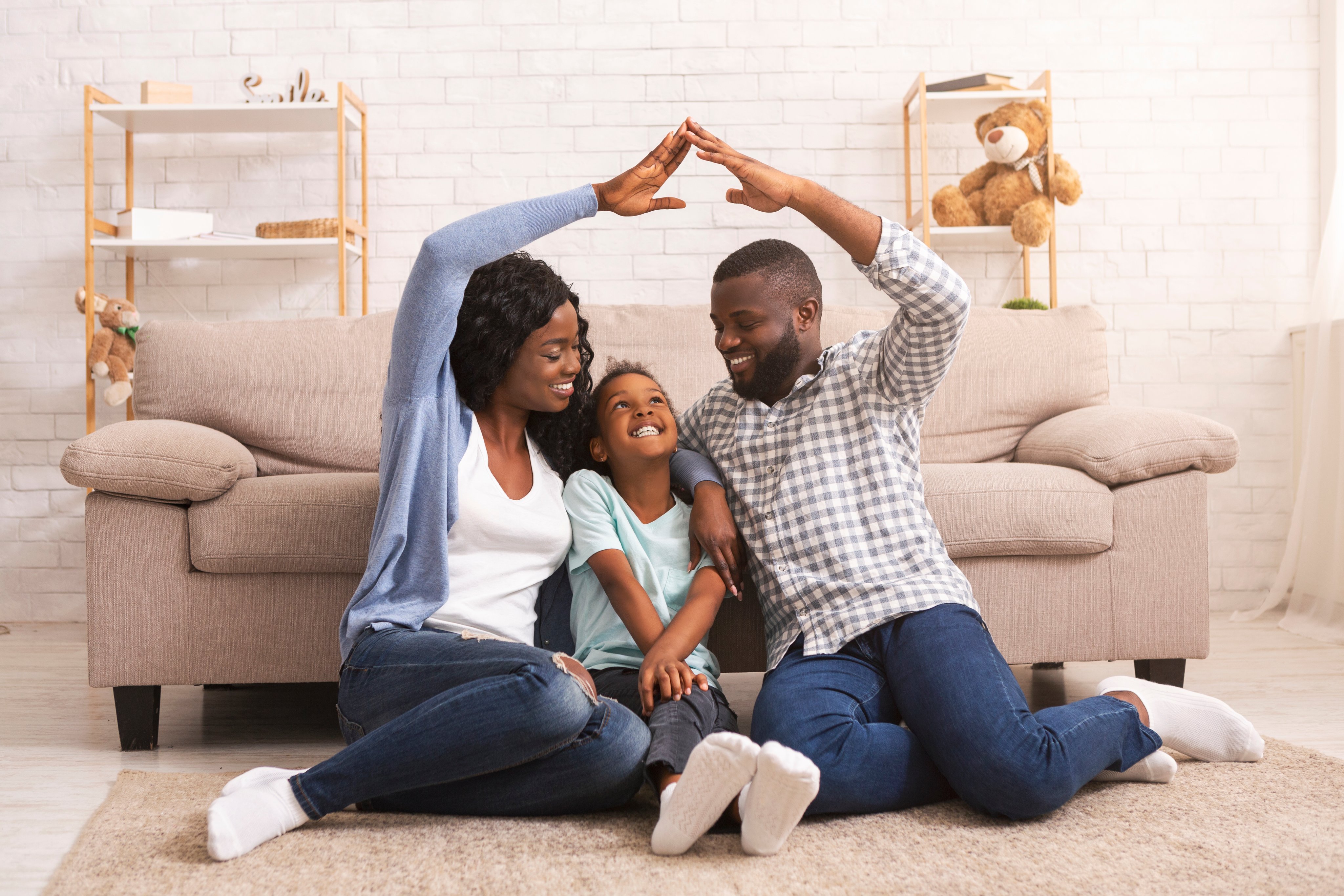Parents and daughter sitting with each other at home