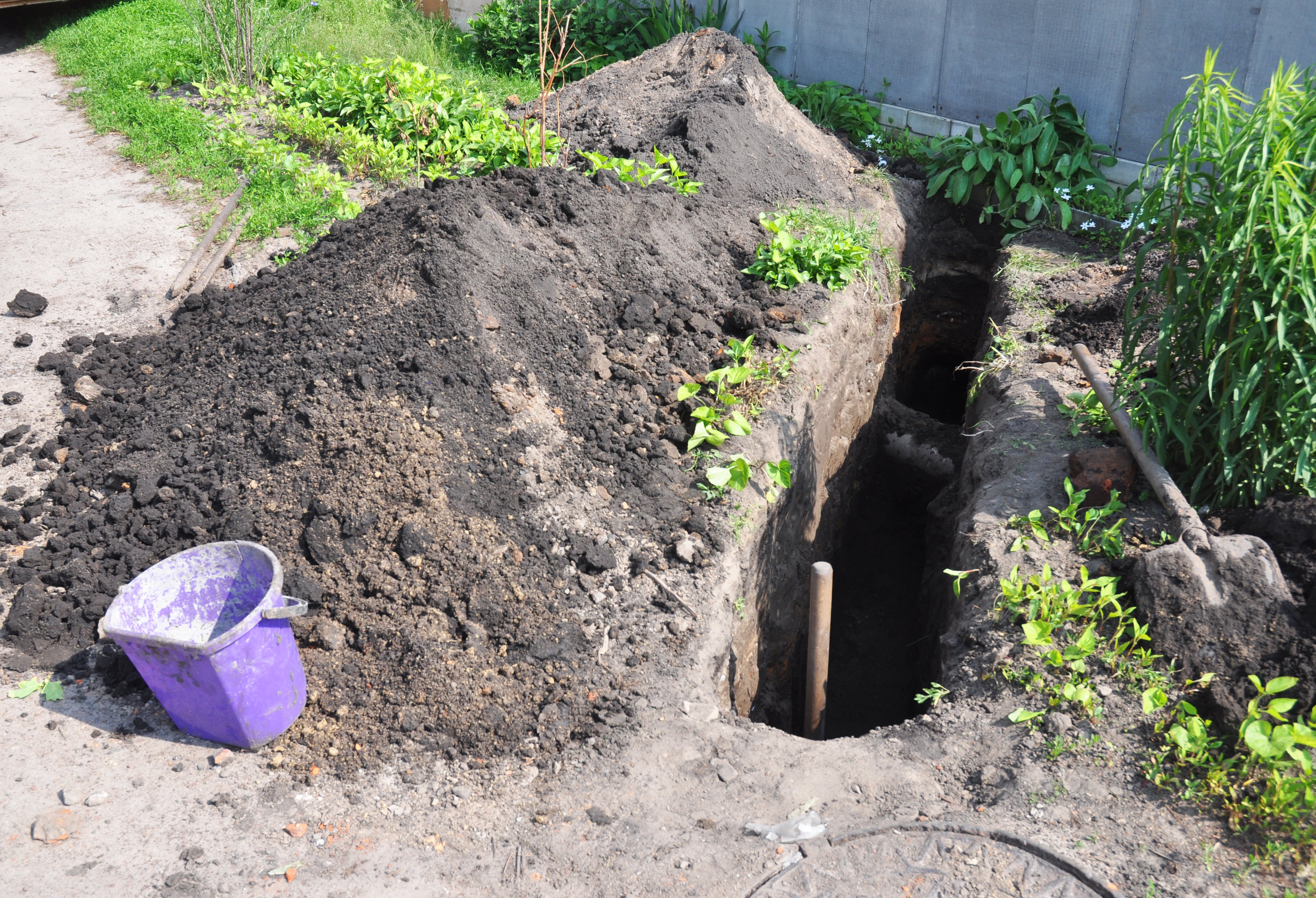 Digging a trench. Earthworks, digging trench. Long earthen trench dug to lay pipe.