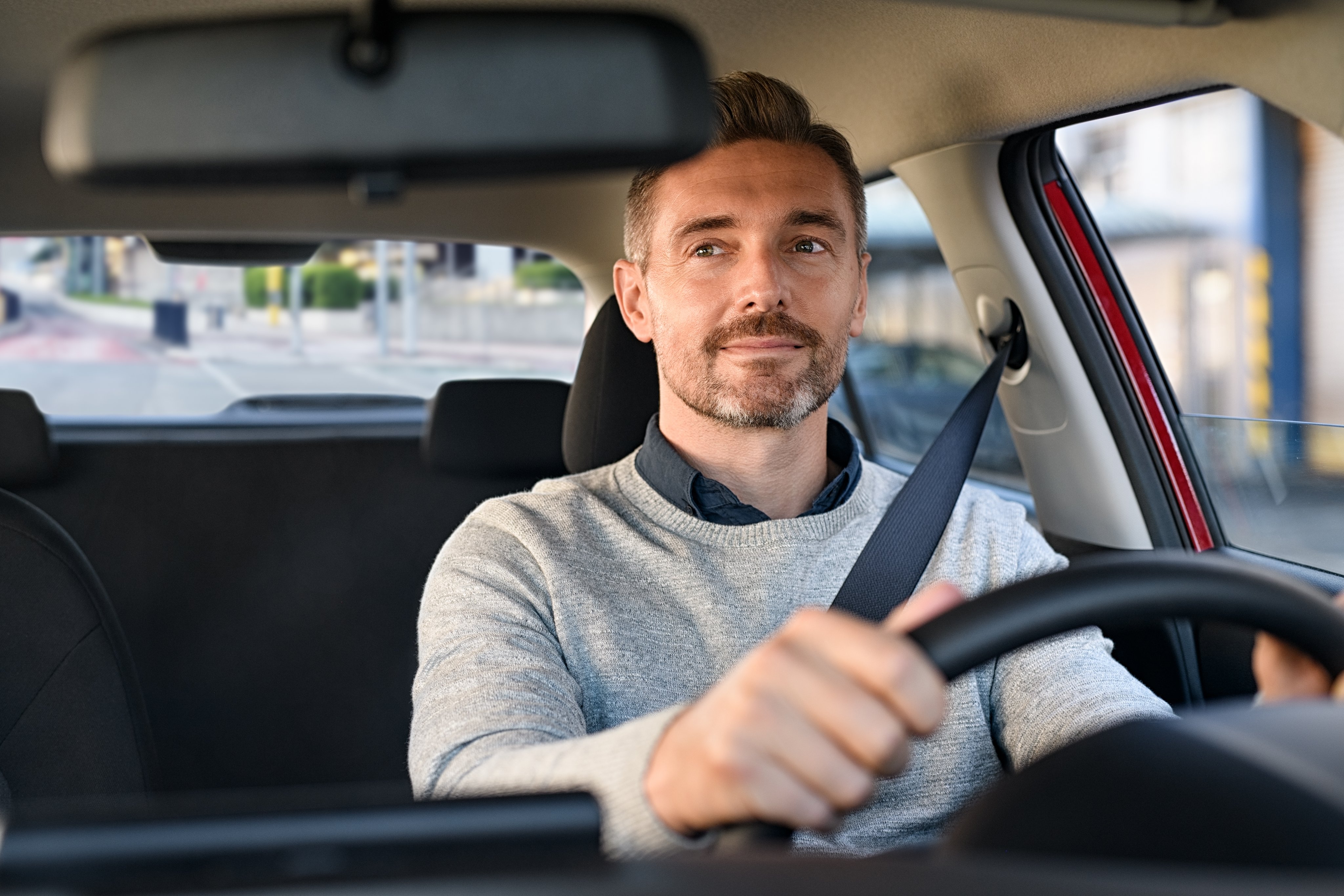 Man driving car and looking at mirror for reverse