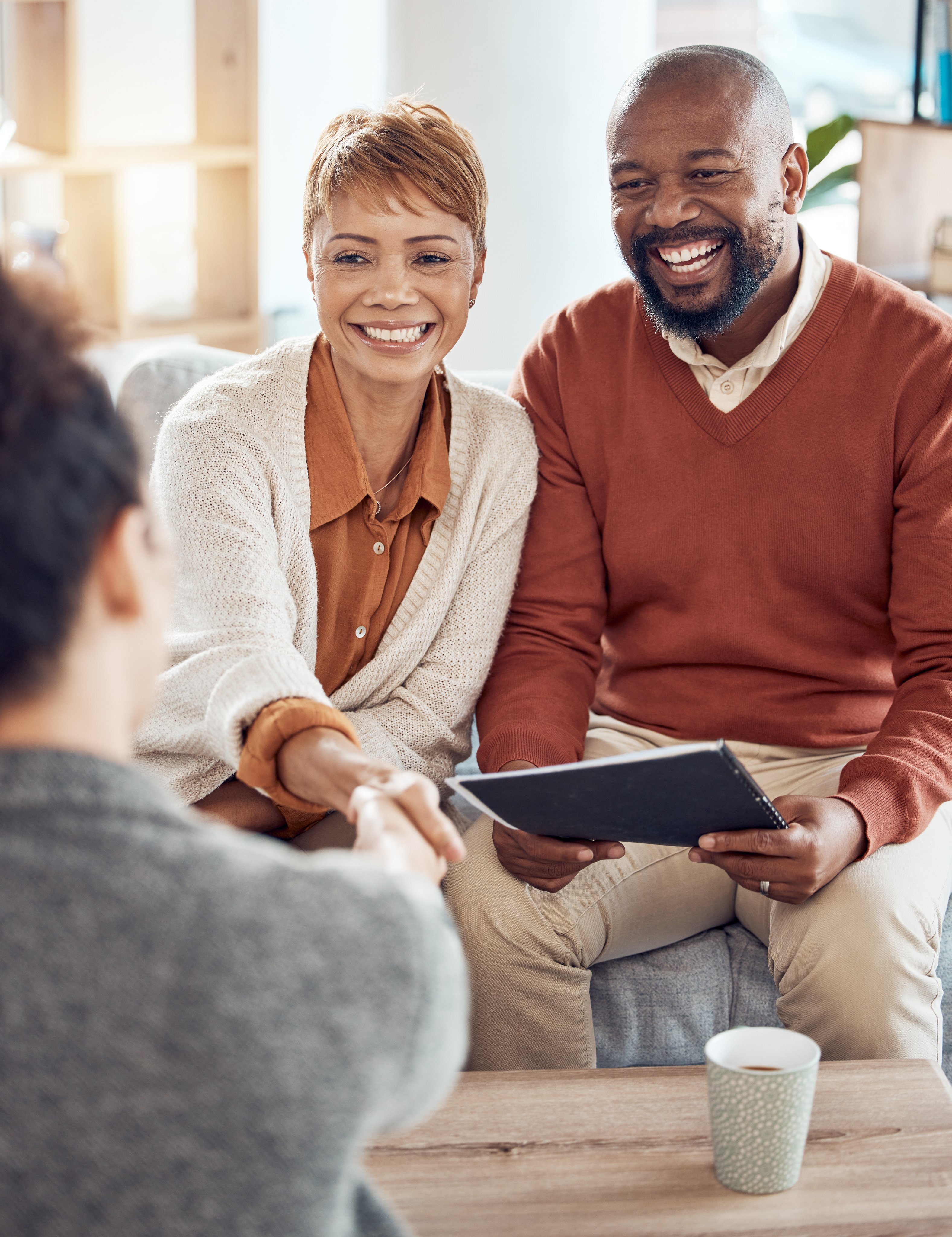 Consulting, planning and handshake with old couple and financial advisor for insurance savings.