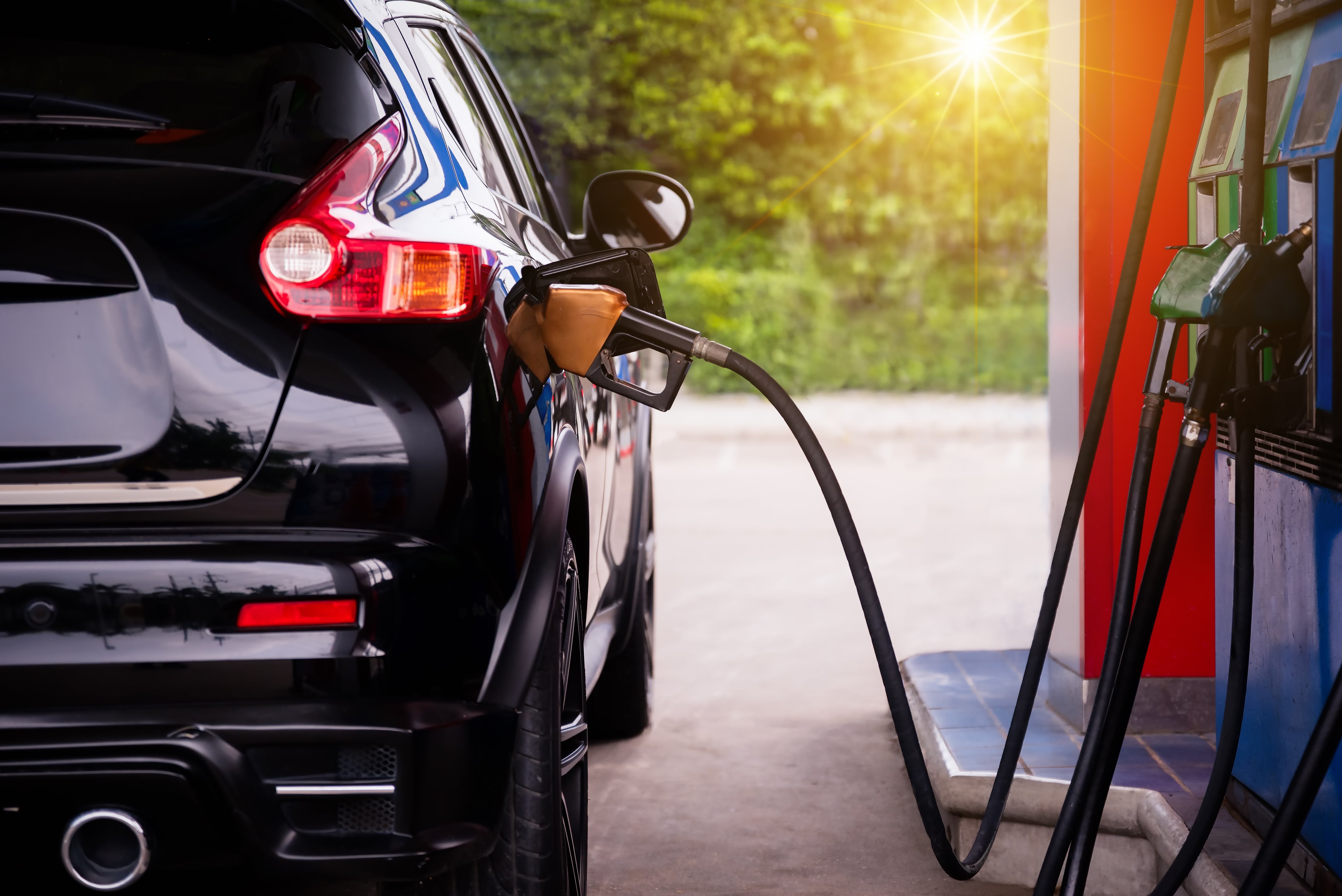 Pumping gas in car at gas station