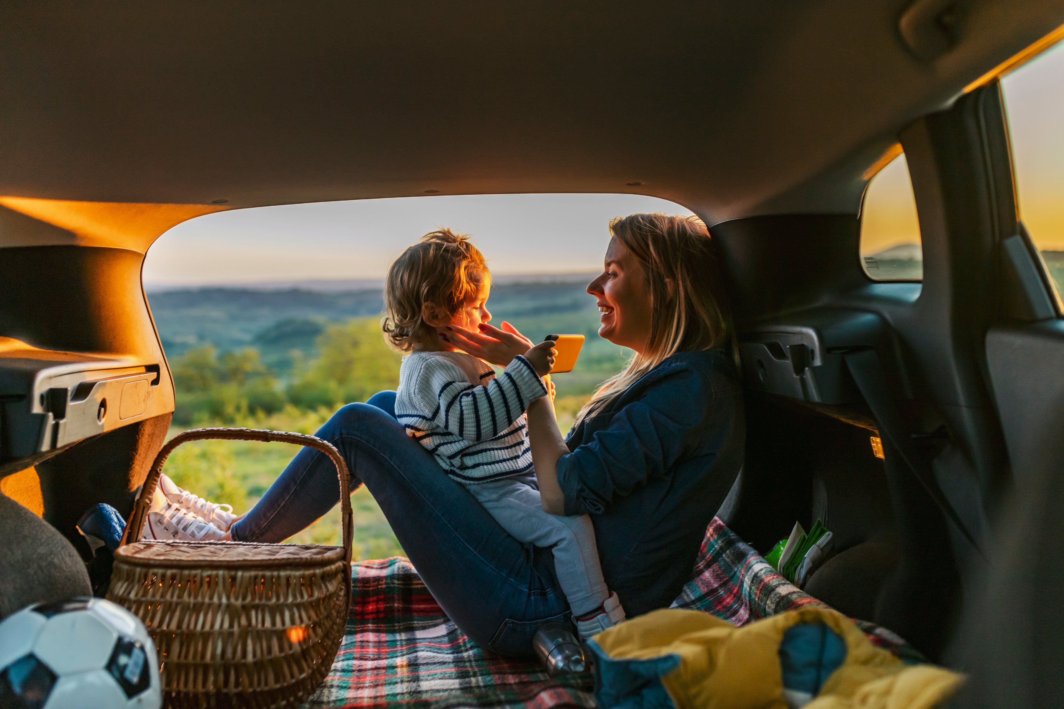 Happy family of mother and son going on a car trip in summer.