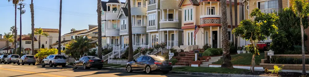 Ornate old Victorian houses on a street lined with palm trees in Orange County, California