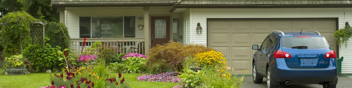 A beautiful Home and manicured yard with a garden full of perennials and annuals.