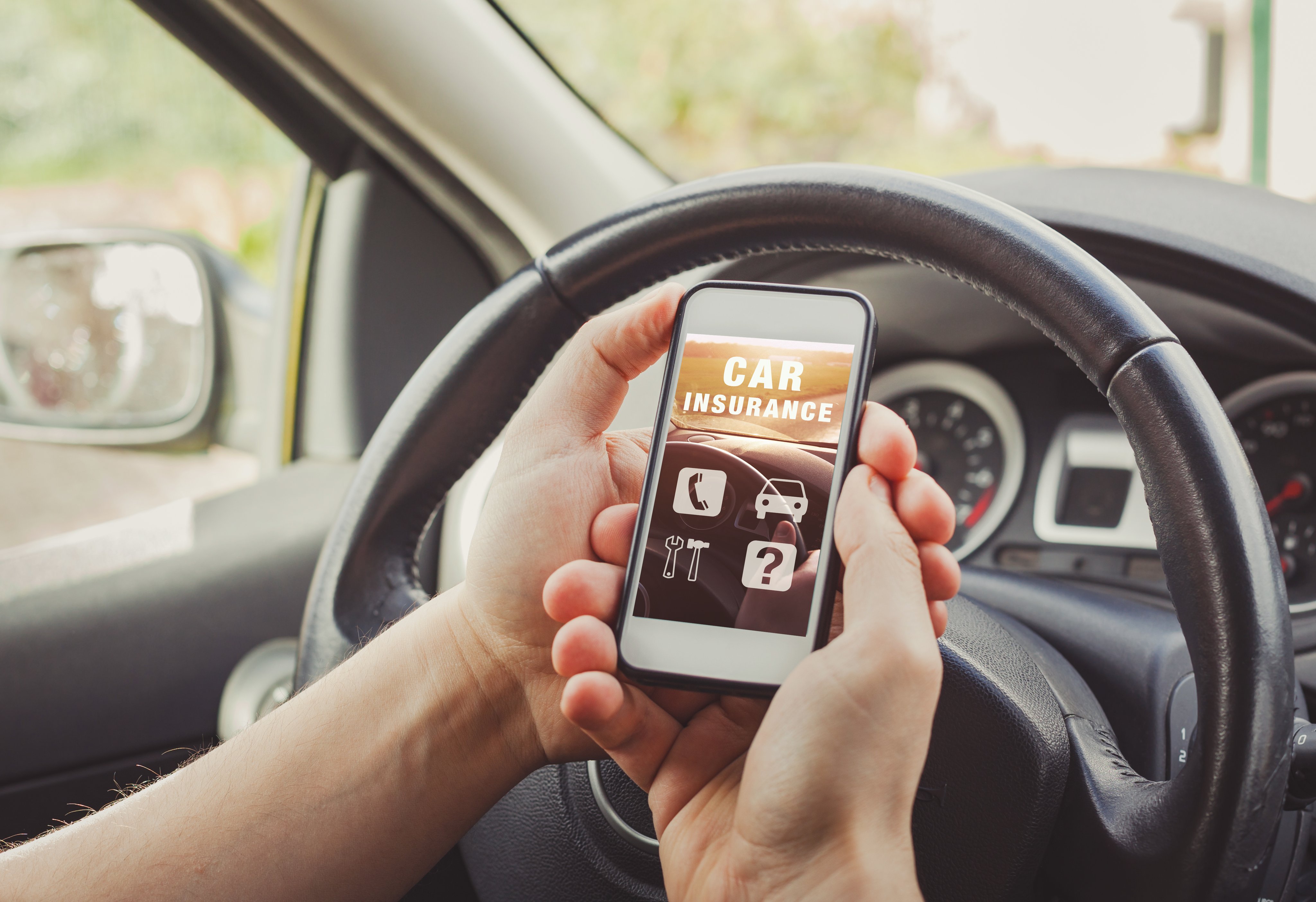 Car insurance reading website on smartphone screen