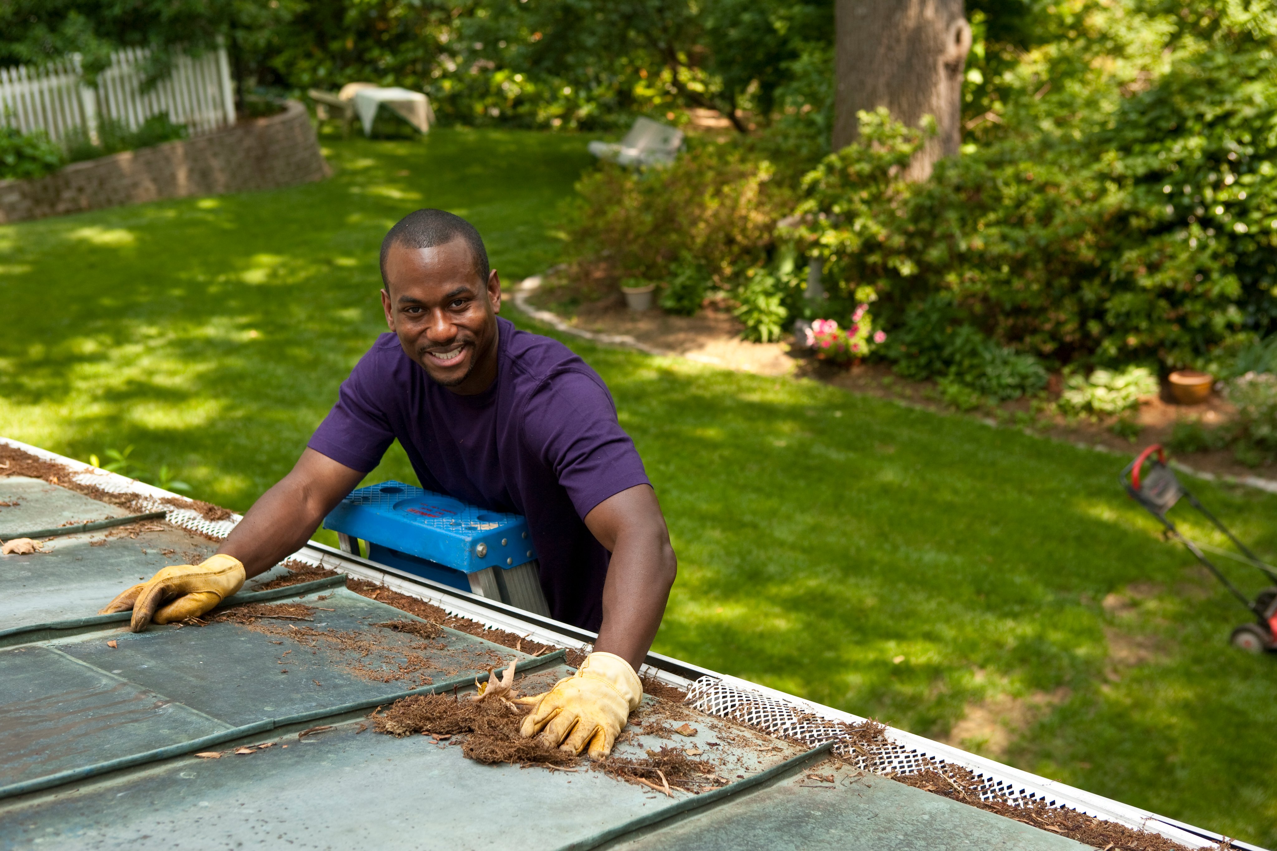 Man cleaning gutters
