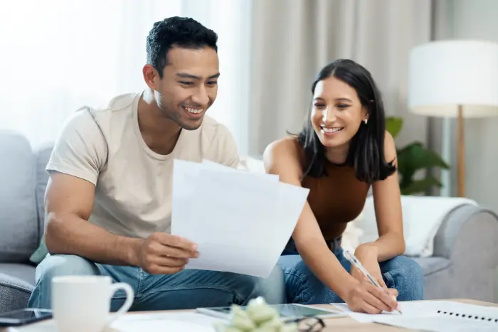 Happy couple budget planning car insurance