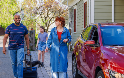 Multi-racial family preparing for a weekend trip in Madison, New Jersey, during springtime