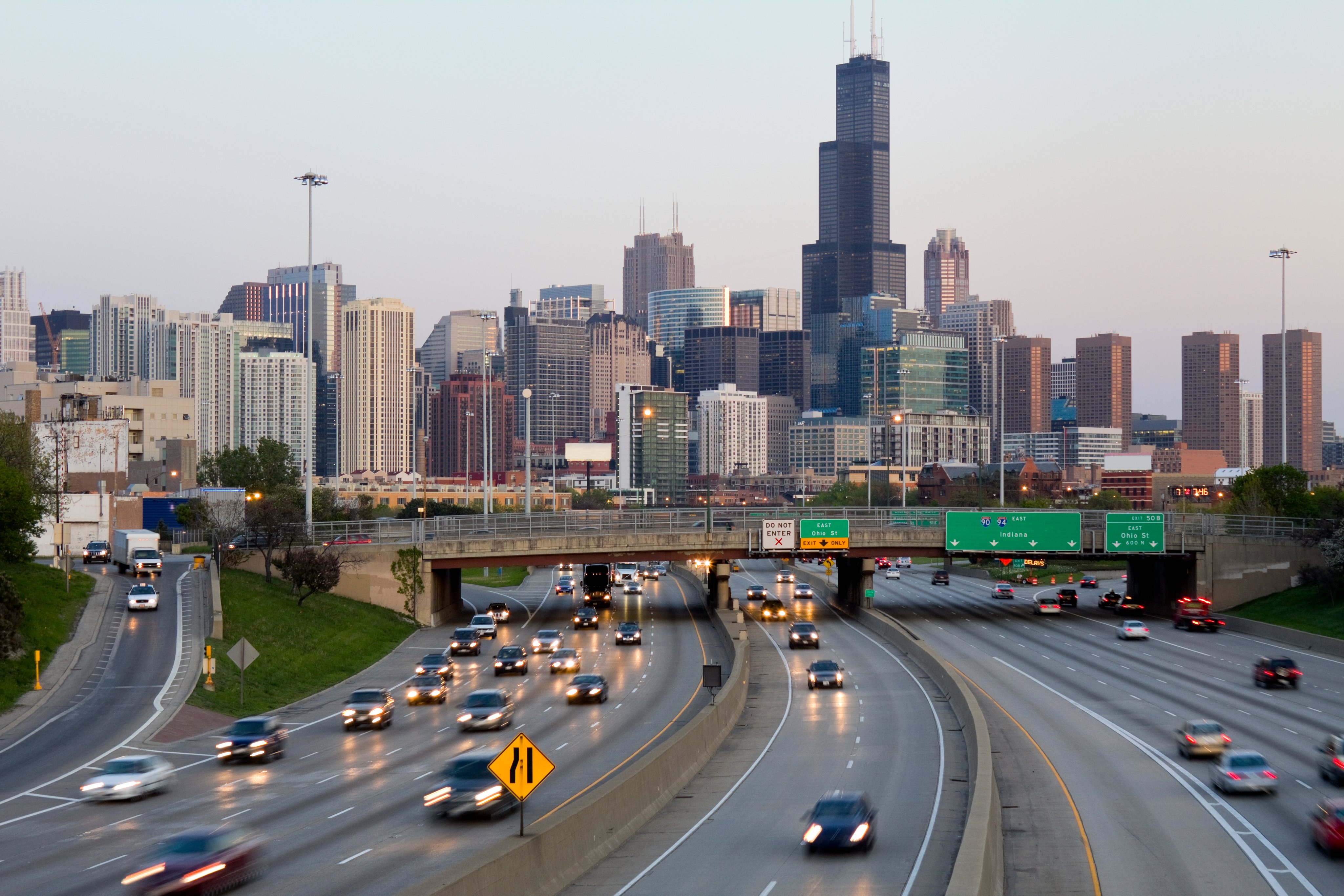 Traffic on the Kennedy Expressway in Chicago at sunset, with downtown behind