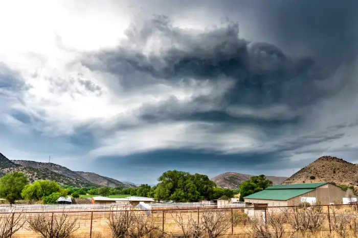 Large, powerful tornadic supercell storm moving over a small town in Oklahoma