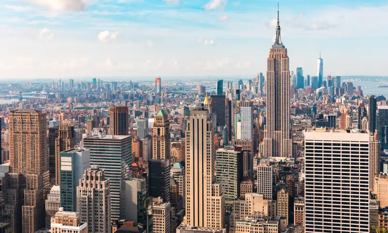 Iconic buildings overlooking bustling new york city with impressive architecture and vibrant energy in warm sunlight