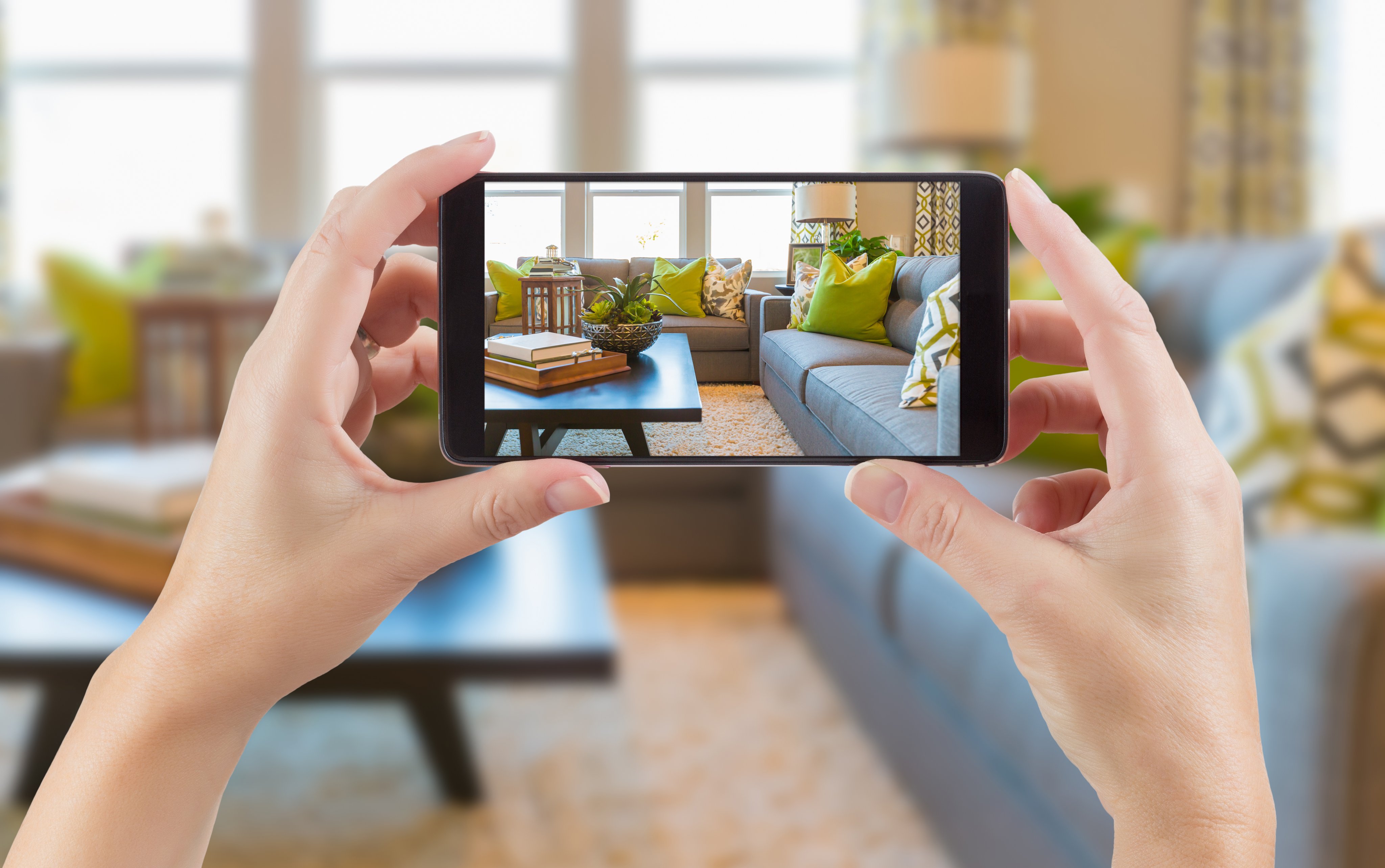Woman taking home inventory photo with a smartphone