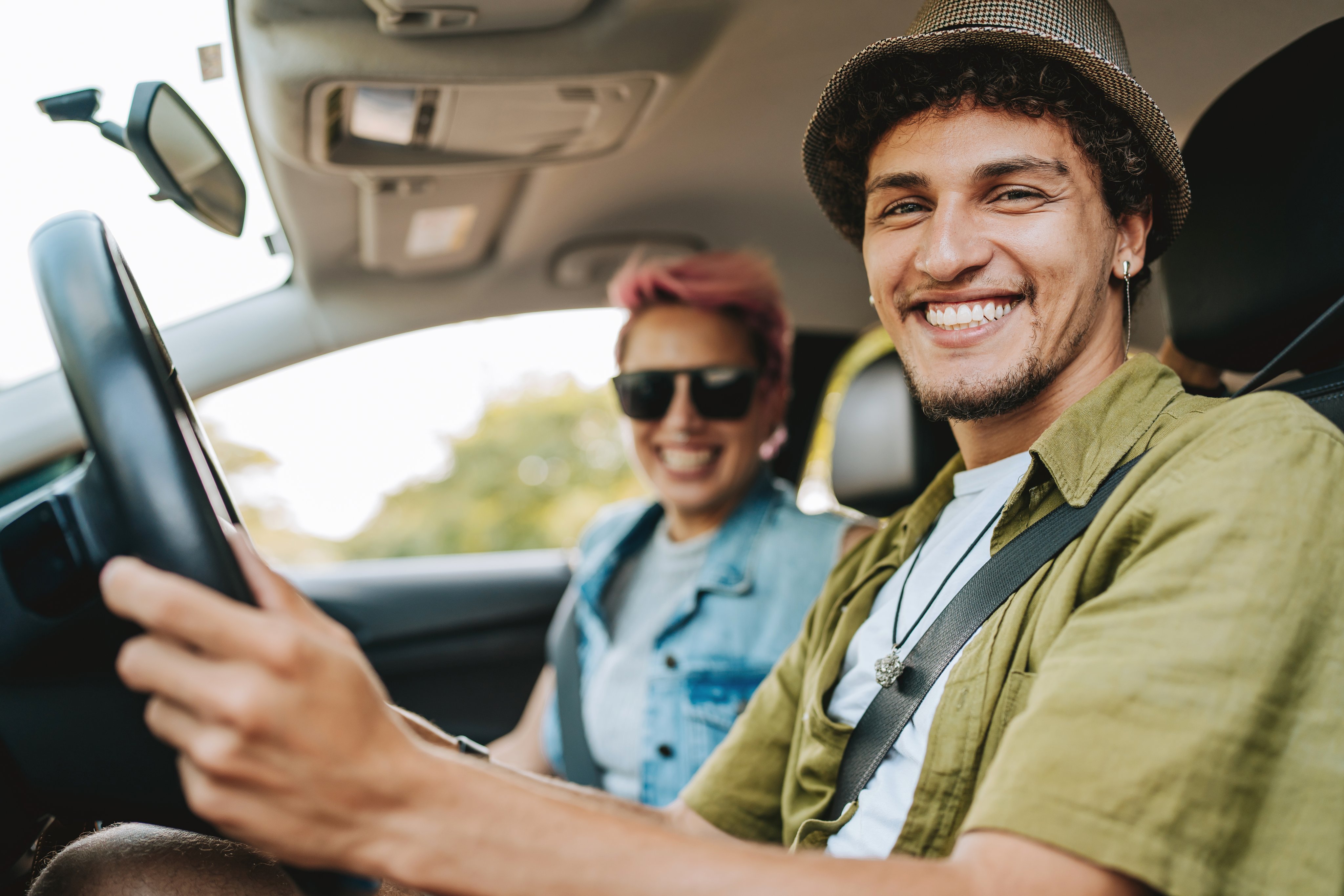 Couple of friends traveling by car