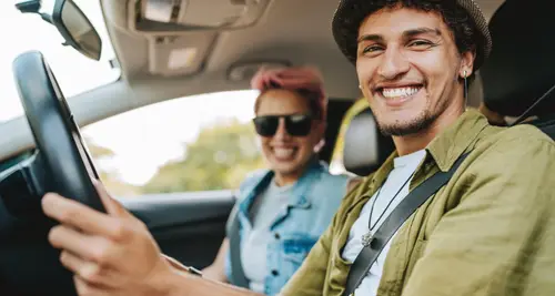 Couple of friends traveling by car