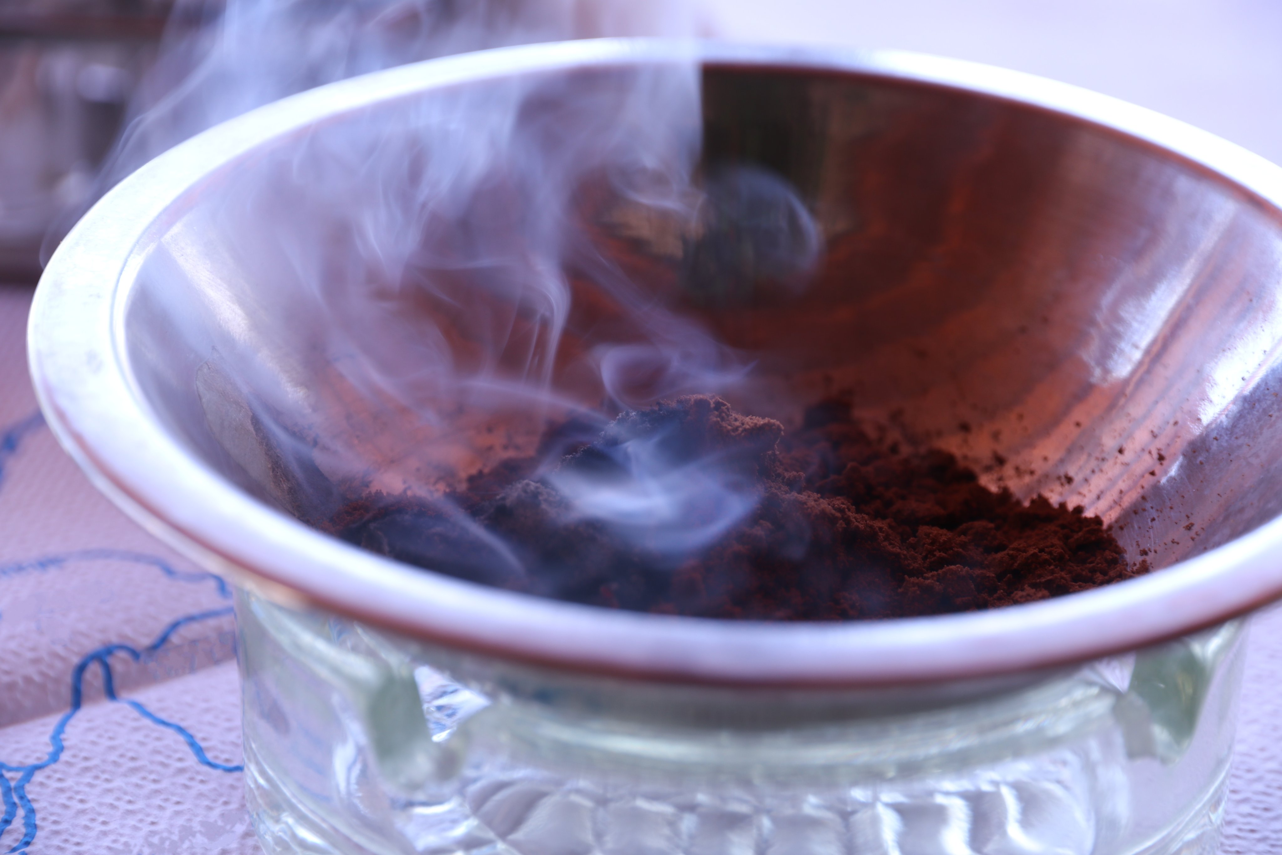 Burning coffee grounds in a tray as a natural method to repel mosquitoes.