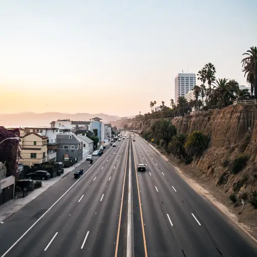 Photo of the top of a brindge in santa monica overlooking the pch while the sun sets