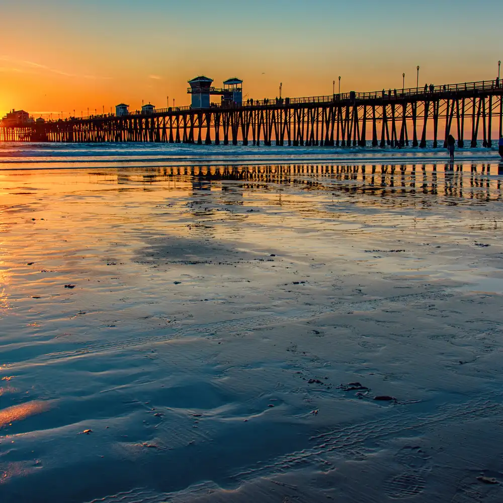 The pier in Oceanside, California located in northern San Diego County as the sun sets behind it.
